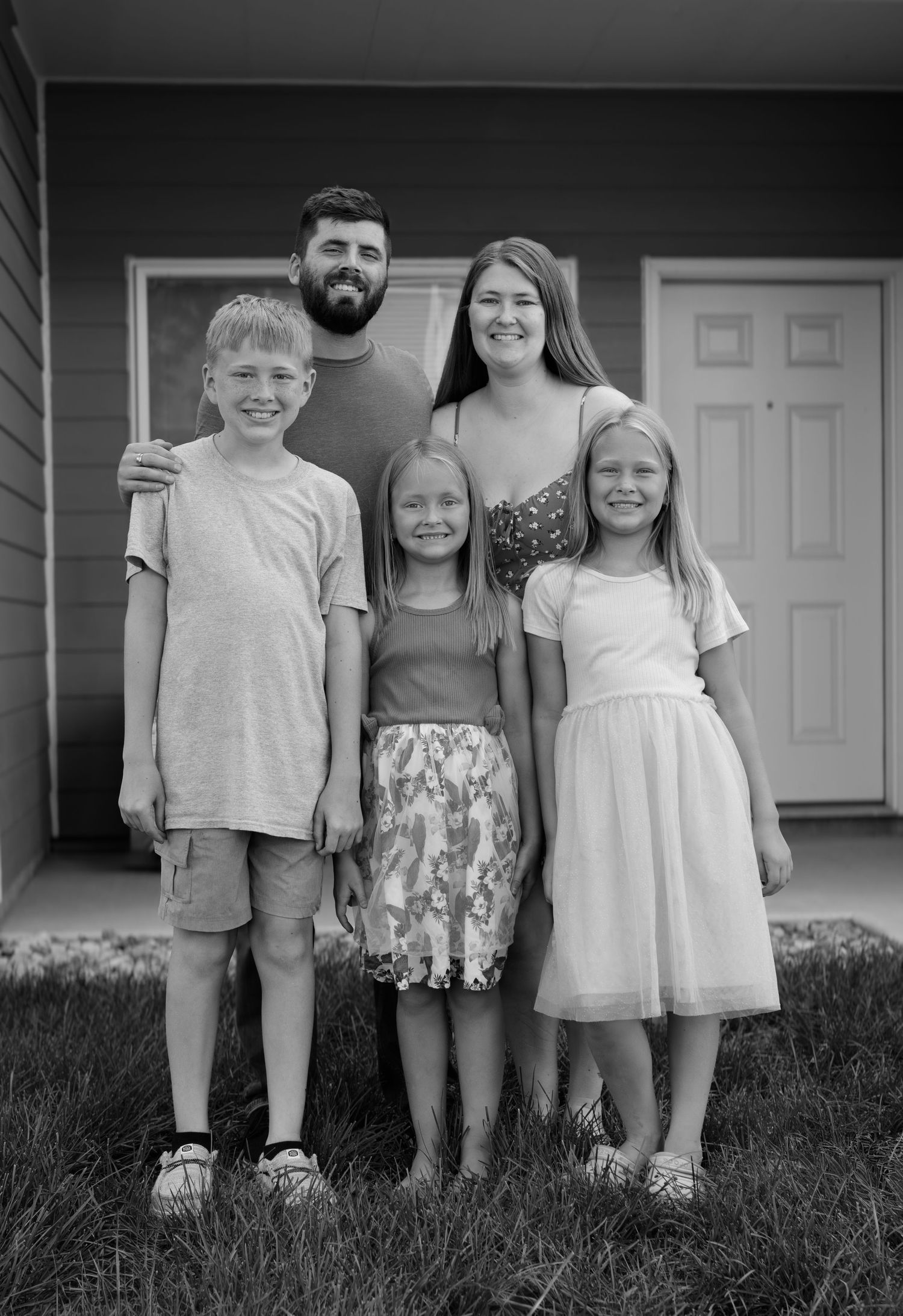 Family posed together in outdoor setting, Sioux Falls professional photography by local Midwest photographer.