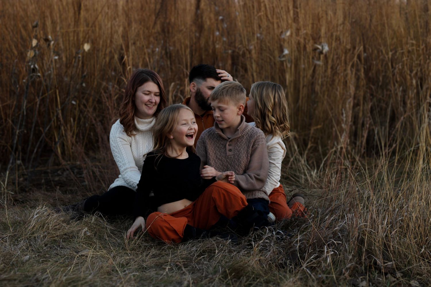 Joyful family portrait with laughter and connection, captured at Arrowhead Park by Sioux Falls expert family photographer.
