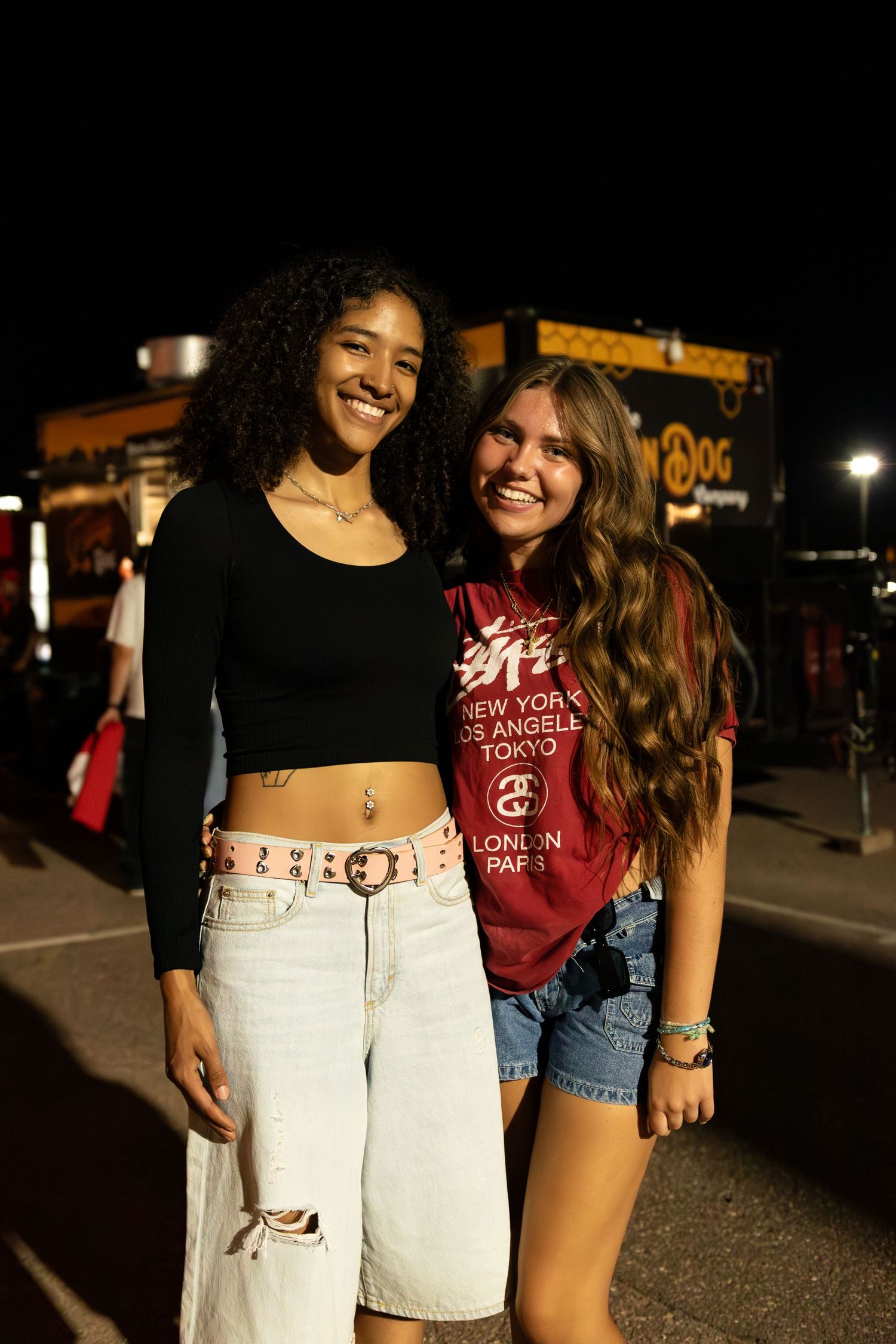 Fashion influencer posing at a night time outdoor fashion event, Second Saturday Market, photographed by a local pro fashion photographer.