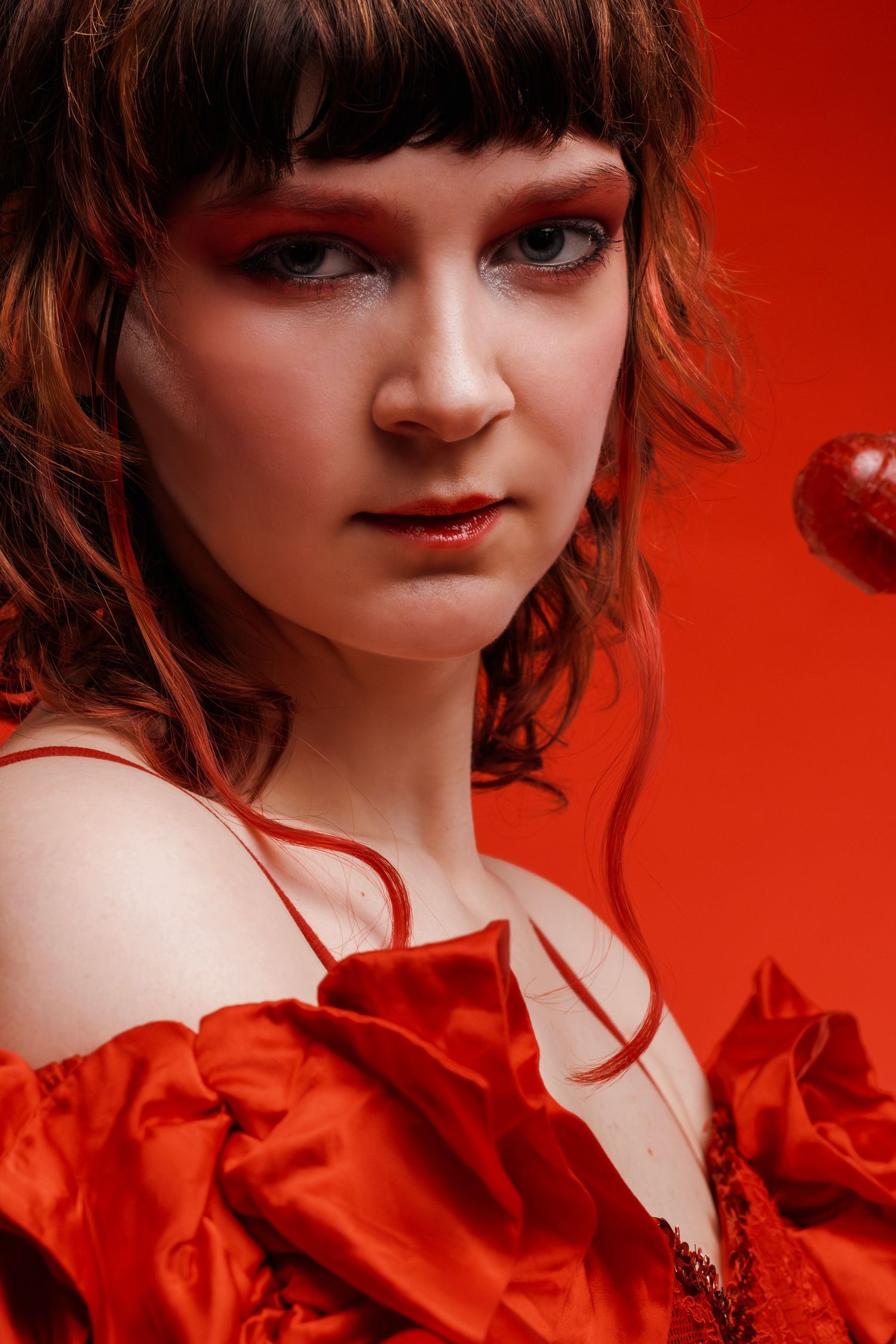 Female model in red monochrome studio editorial portrait, captured by Sioux Falls photographer highlighting fashion, color, and modern style