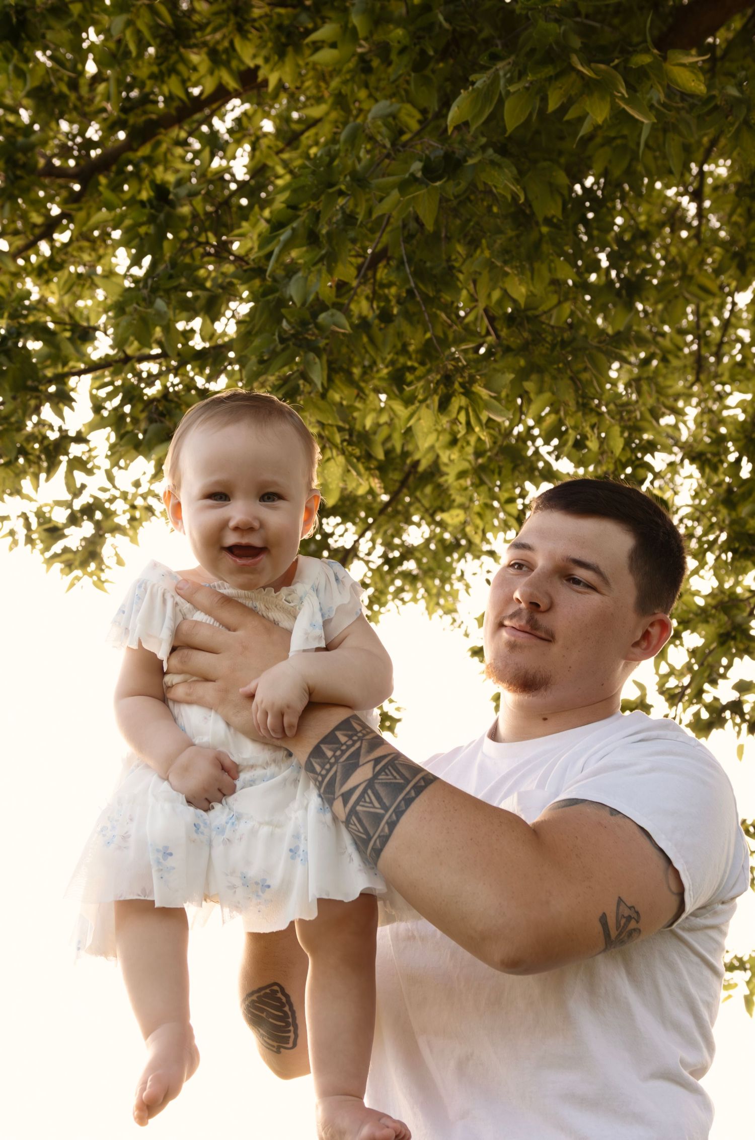 Father and child sharing a joyful moment, photographed by local professional family photographer in Sioux Falls.