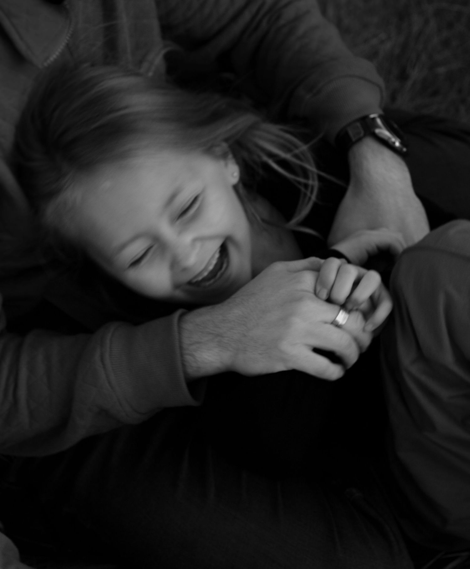 Candid family moment with child and parent, photographed by Sioux Falls professional family photographer at Arrowhead Park.
