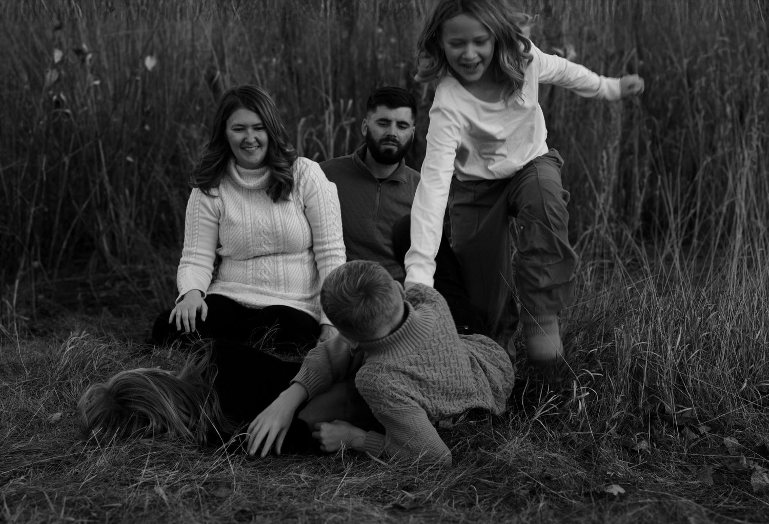 Joyful family portrait at Arrowhead Park with laughter and connection, captured by expert Sioux Falls family portrait photographer.