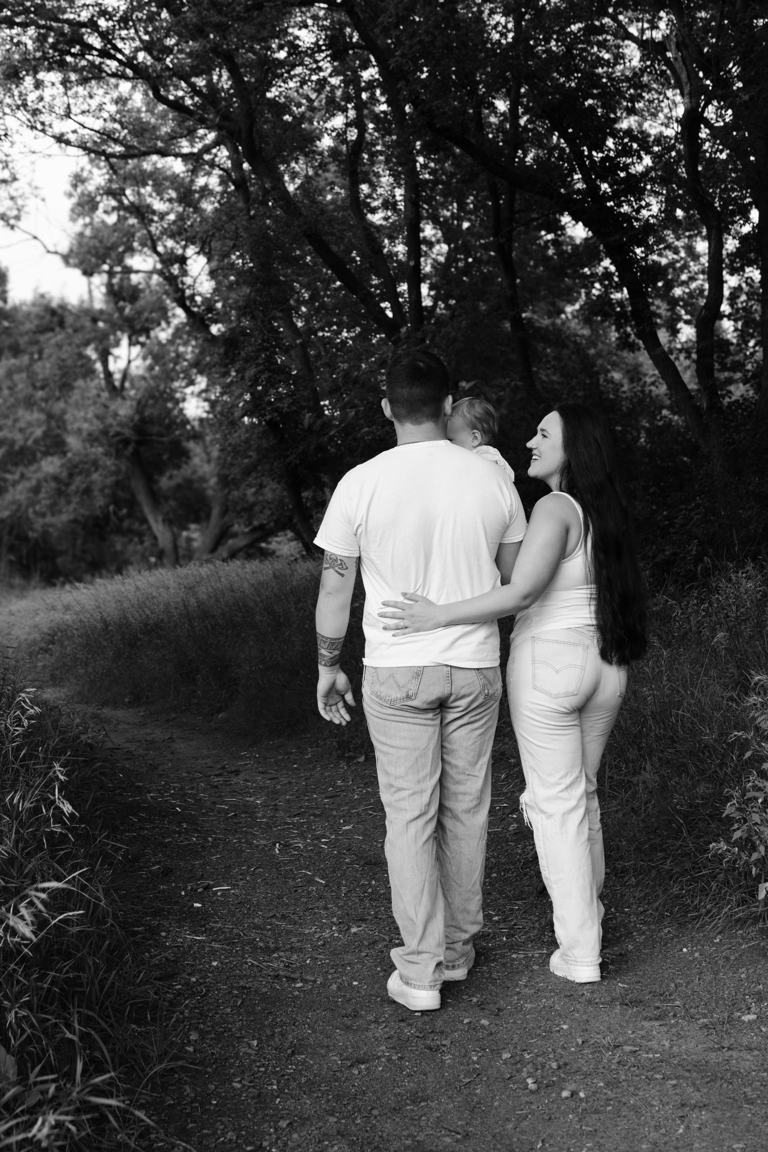 Family enjoying time together in a natural setting, professional photography by local Sioux Falls expert family photographer.