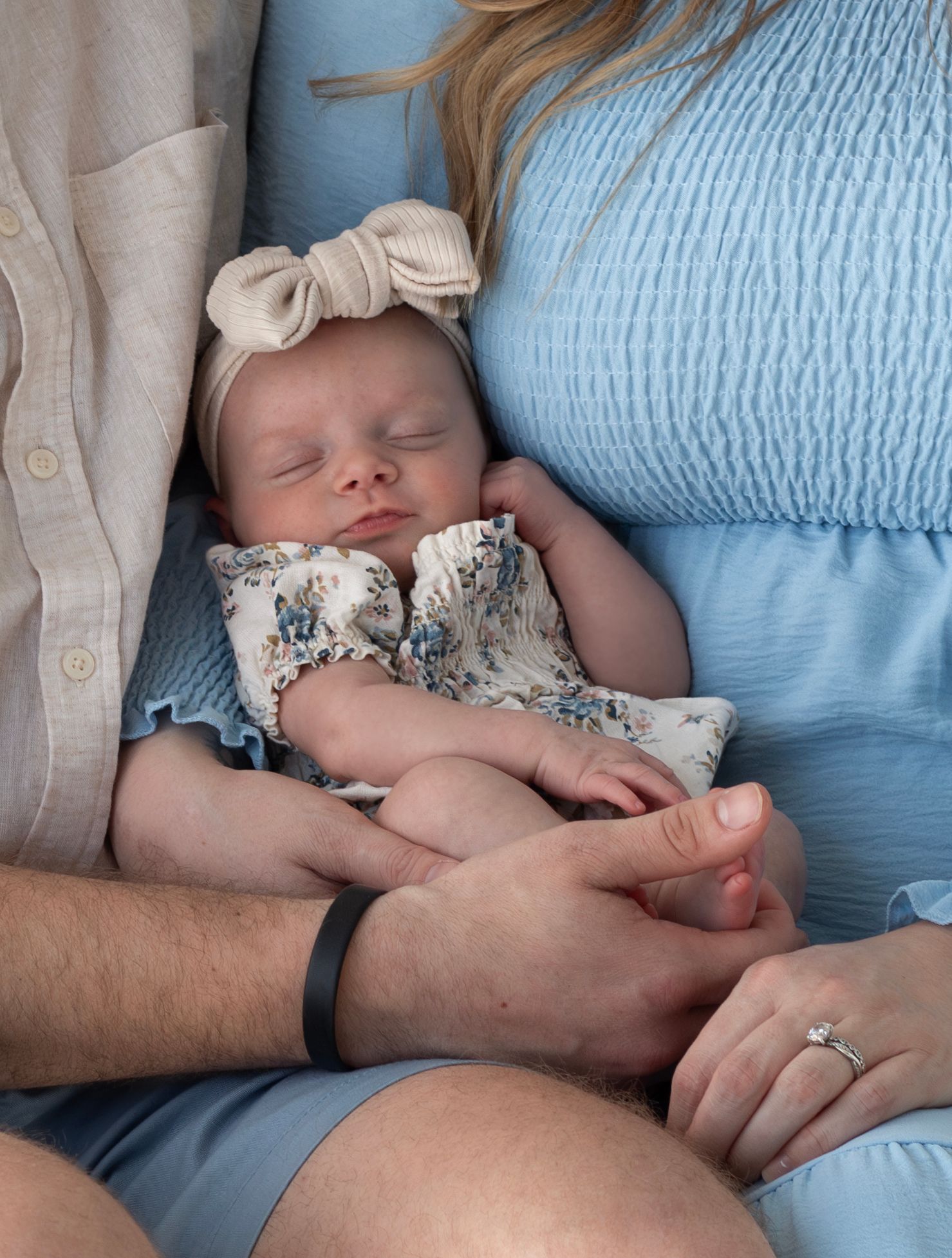 Family posed together in indoor natural light setting, professional photography by local Sioux Falls photographer.