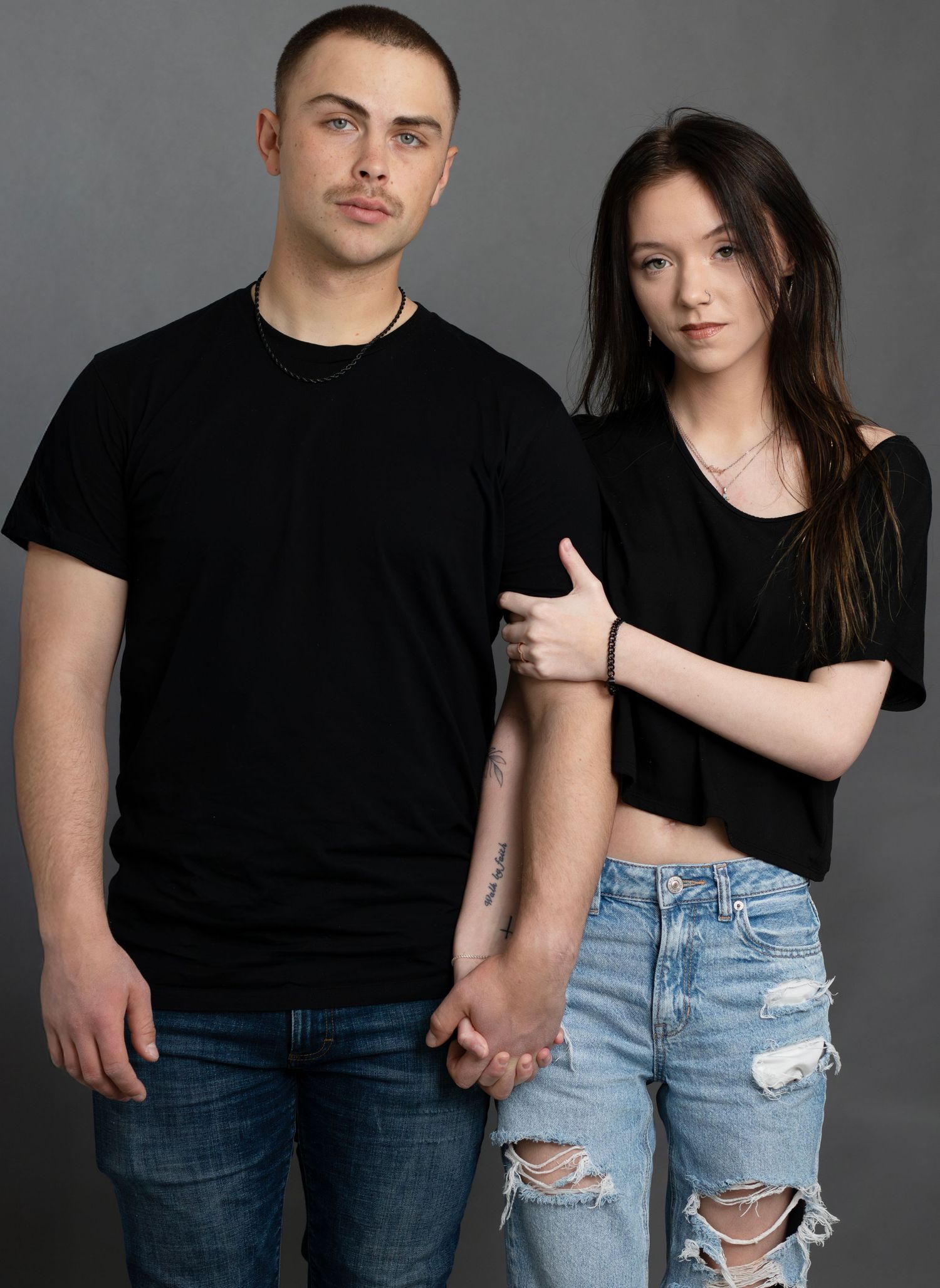 Couple posed in Sioux Falls studio, professional portrait capturing their personalities, connection, and styled indoor couples photography