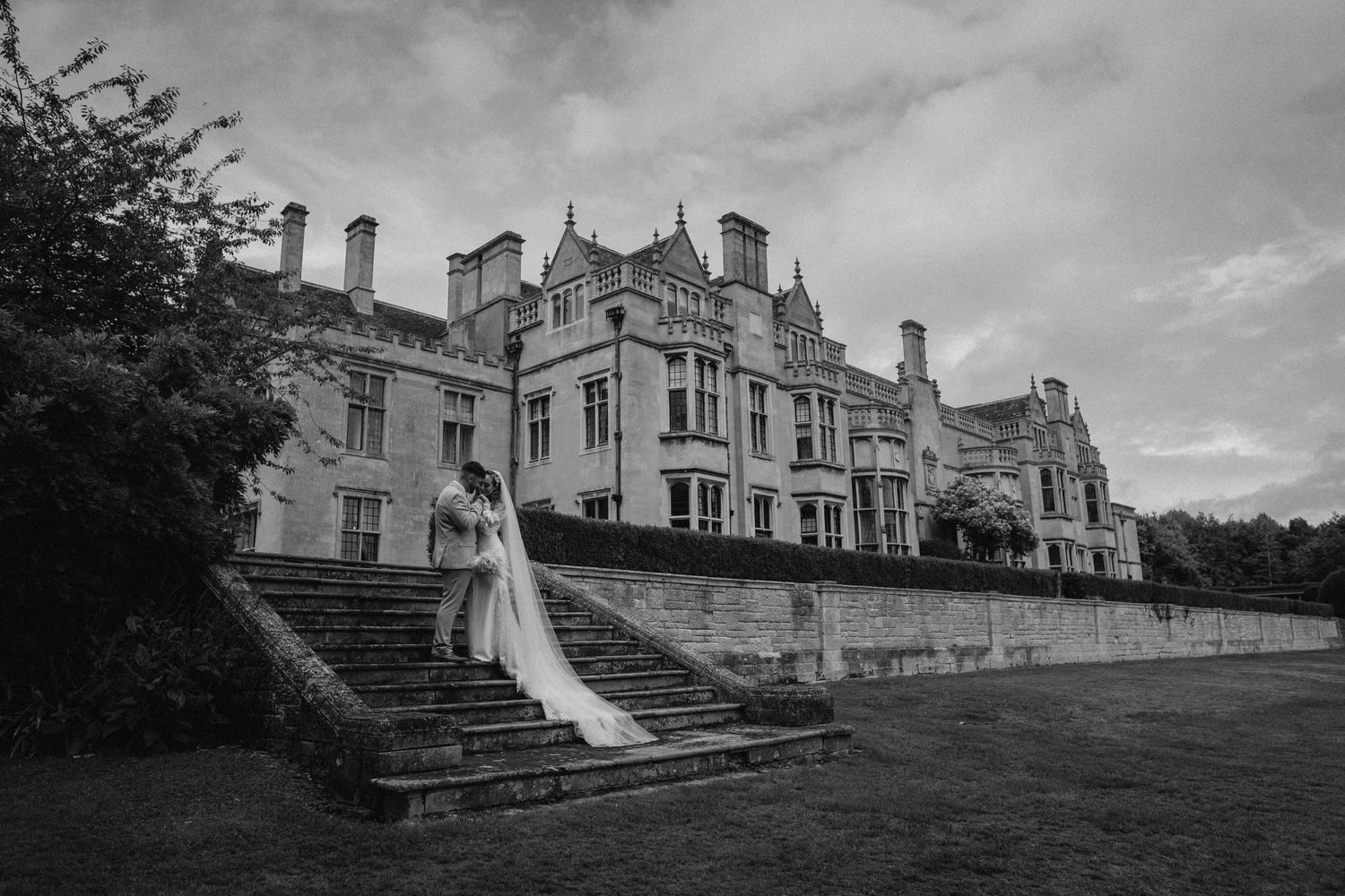 A collection of seven black and white landscape photos showing various architectural views of a historic stone mansion. Wedding photography.