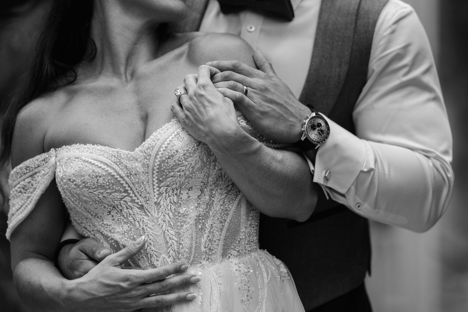 Close-up detail of hands holding during an intimate wedding moment at Harlaxton Manor.