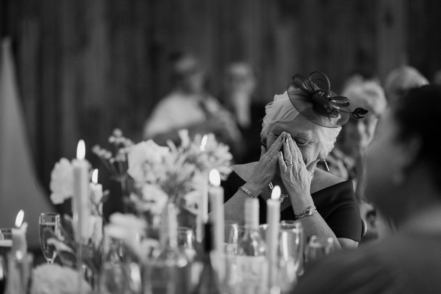 Black and white photo of candlelit table settings at an intimate wedding reception at The Manor House at Quorn.