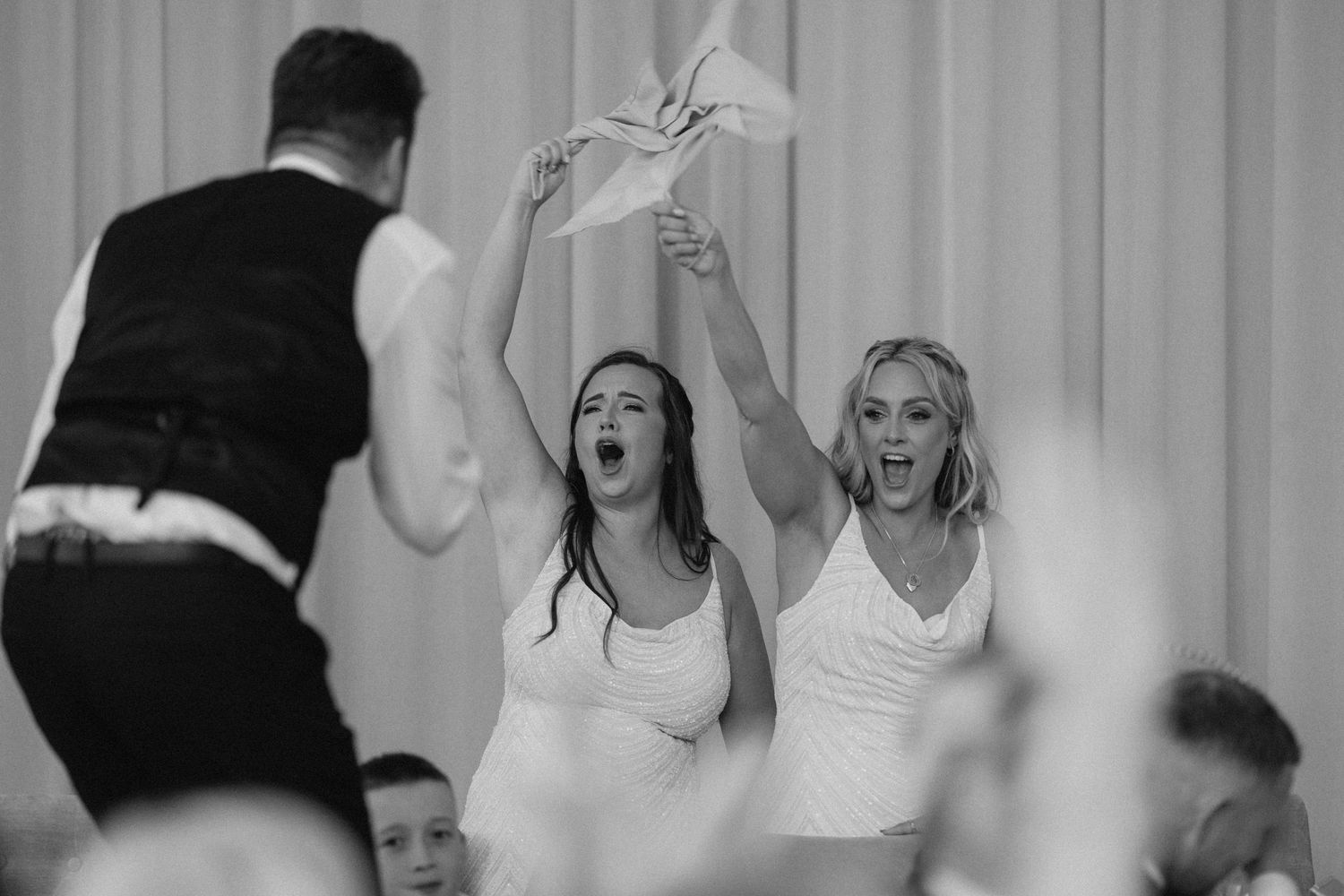 A lively wedding reception with guests dancing and celebrating in a festive atmosphere.