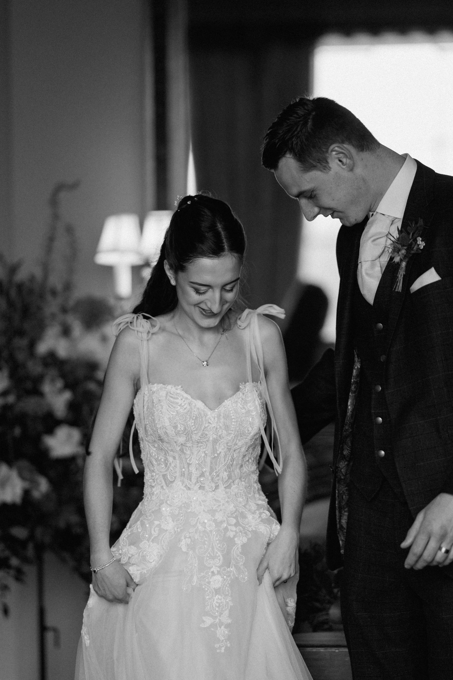 Black and white candid moment between couple in wedding attire at Prestwold Hall.