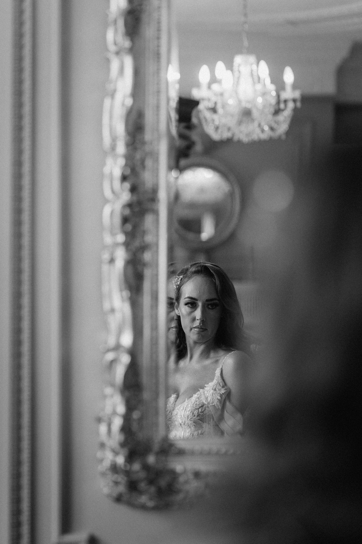Artistic black and white reflection in an ornate mirror. Wedding photography at Rushton Hall