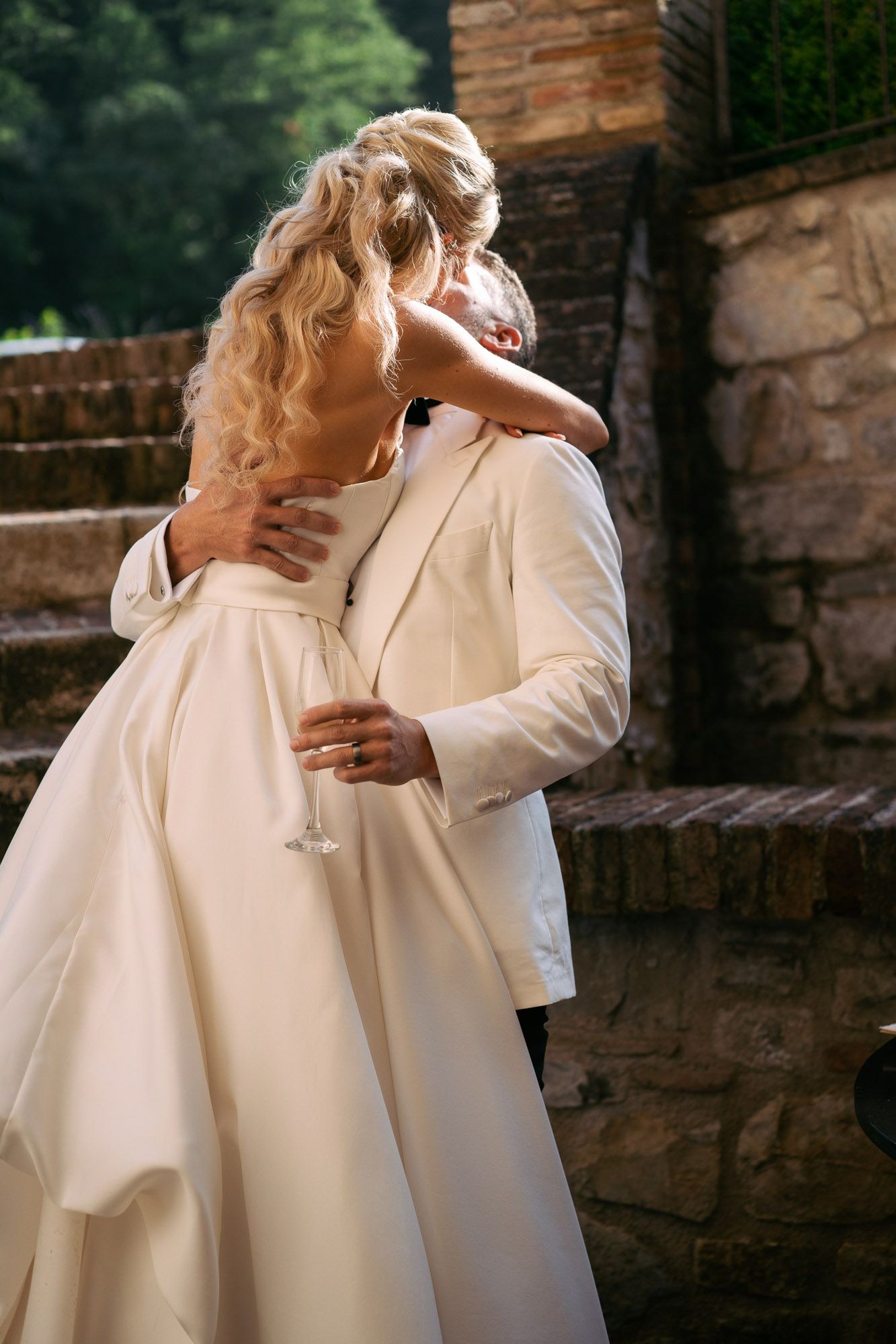 A series of romantic wedding photos showing tender moments between a couple against a rustic stone wall backdrop. wedding photographer Italy