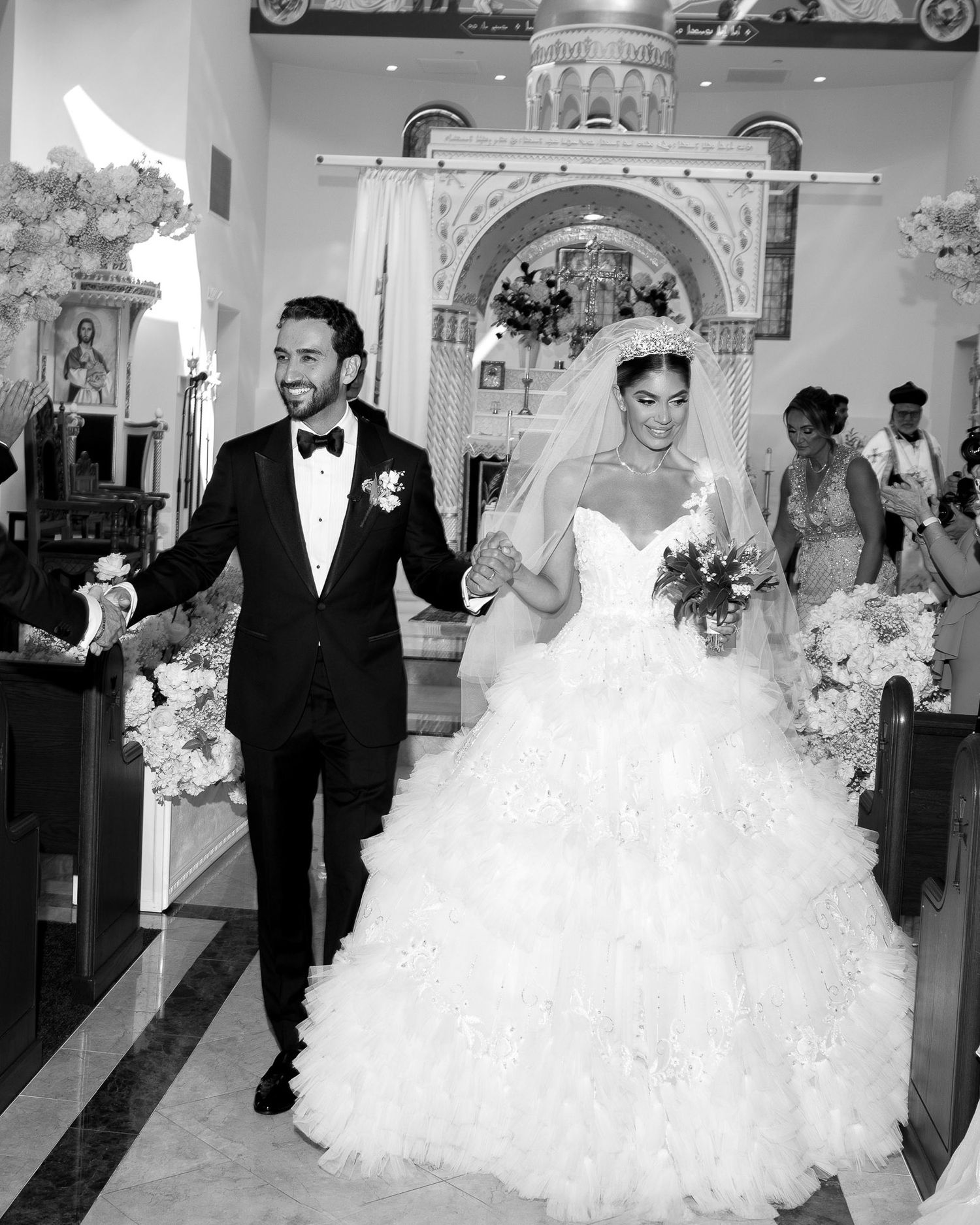 A black and white collage of wedding ceremony moments showing a bride and her escort walking down church aisles.
