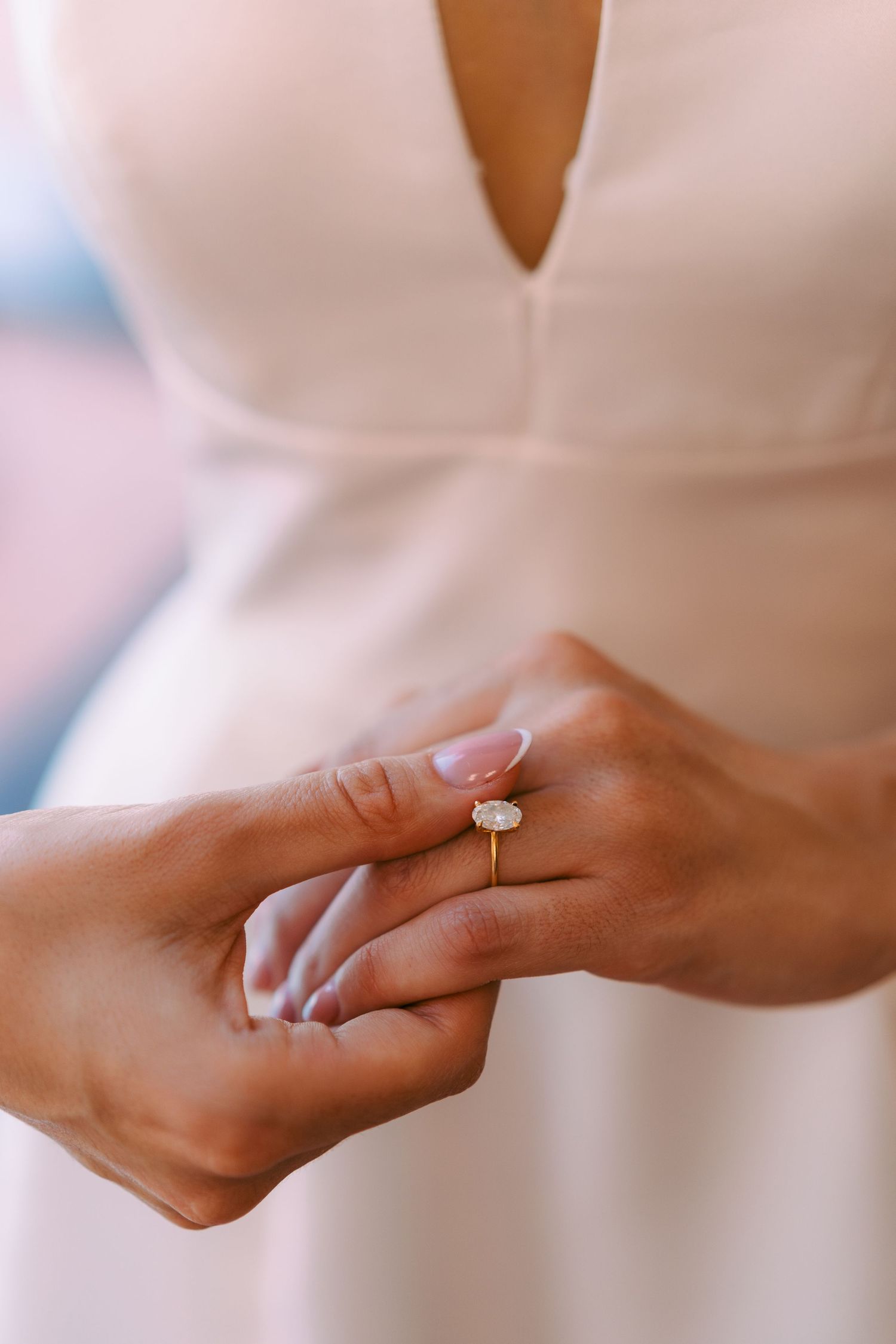Close-up of hands wearing elegant rings and jewelry.