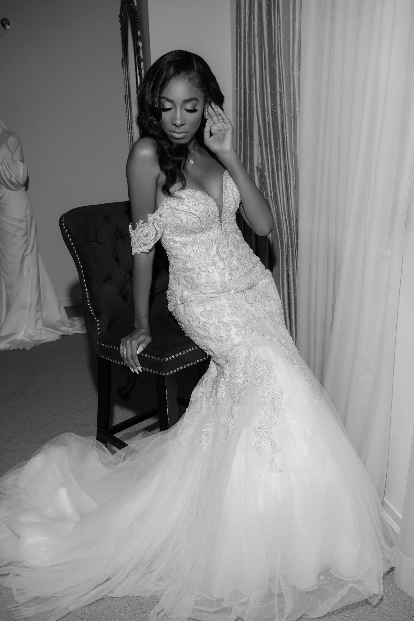 A collage of four photos showing a bride in a white lace and tulle wedding gown being fitted and styled.