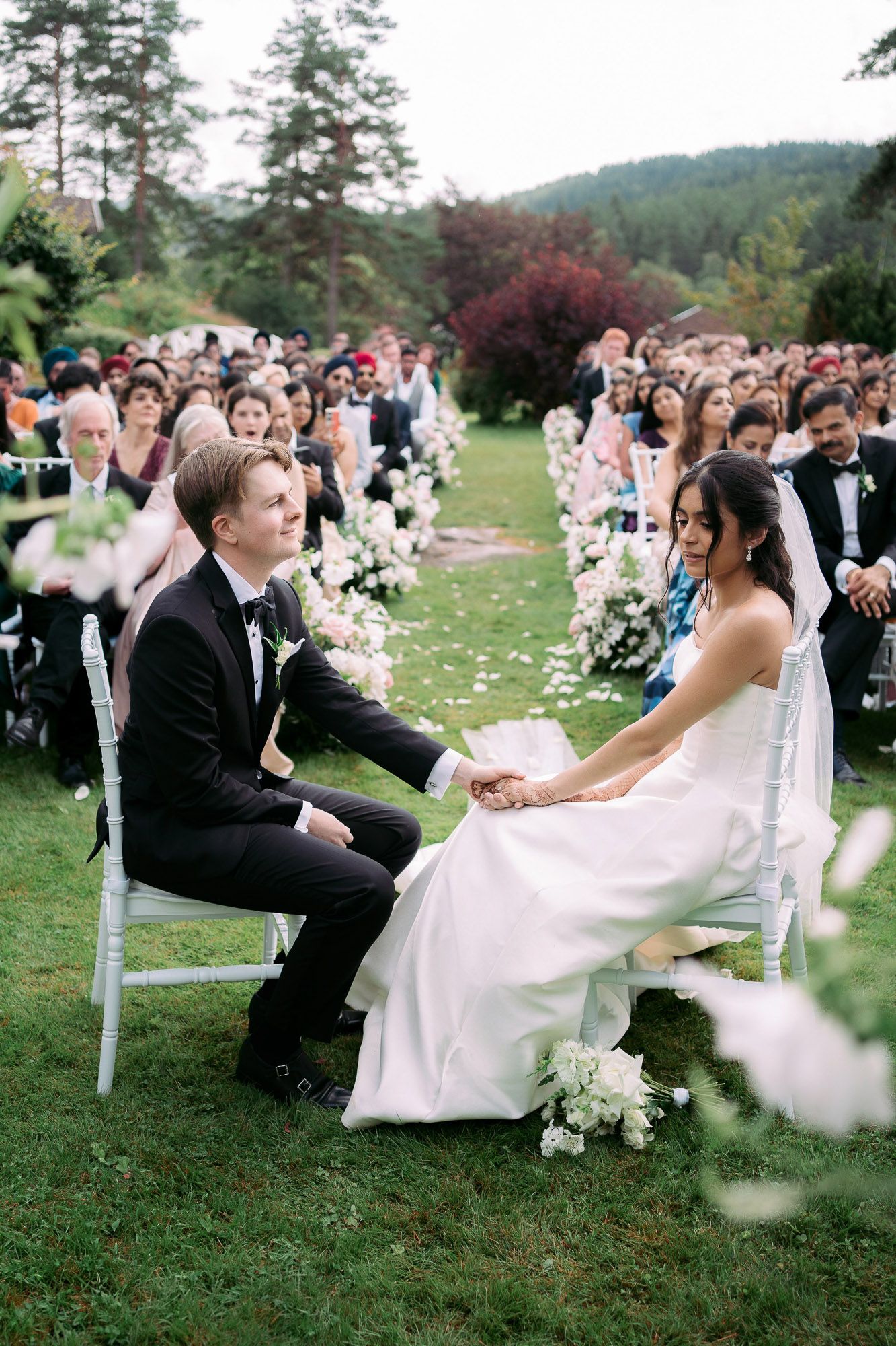 A sequence of wedding photos showing a couple seated on swings during their outdoor ceremony in a scenic garden setting.