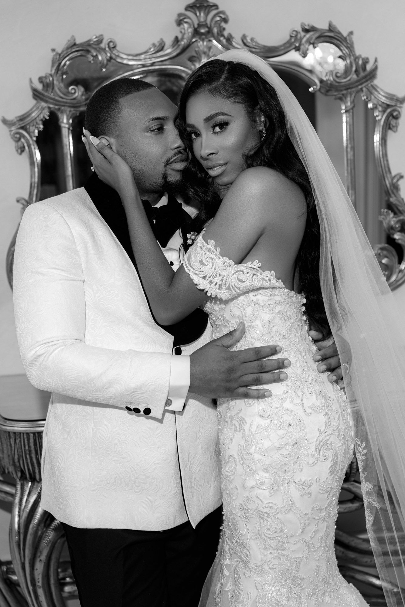 A romantic black and white wedding photo series showing tender moments between a couple in formal attire.