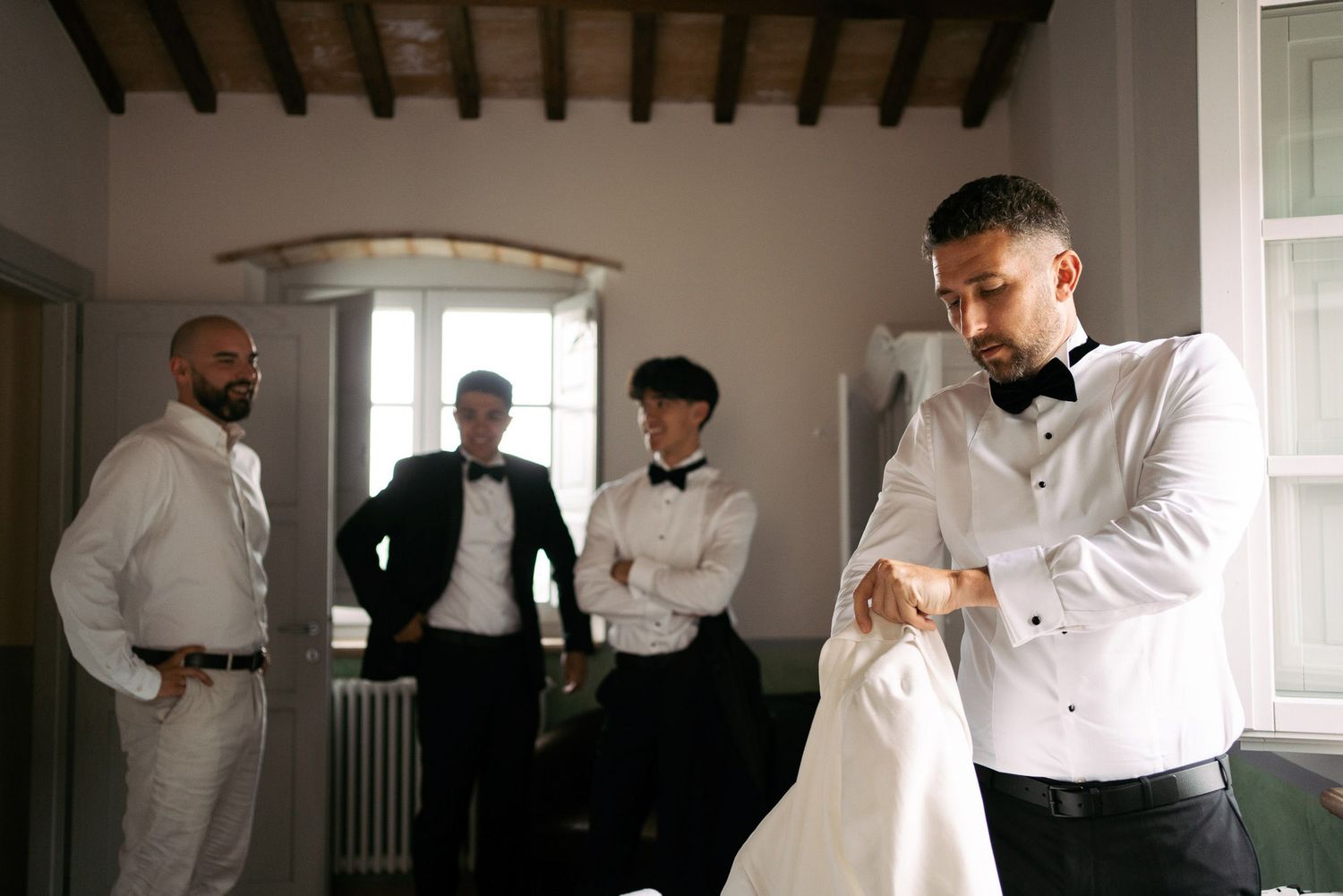 A series of black and white photographs showing people in formal attire preparing and getting dressed.