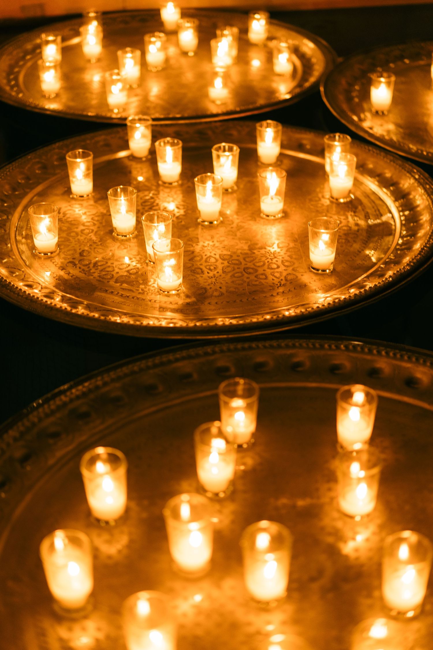 Glowing votive candles arranged in circular pattern creating romantic wedding ambiance.