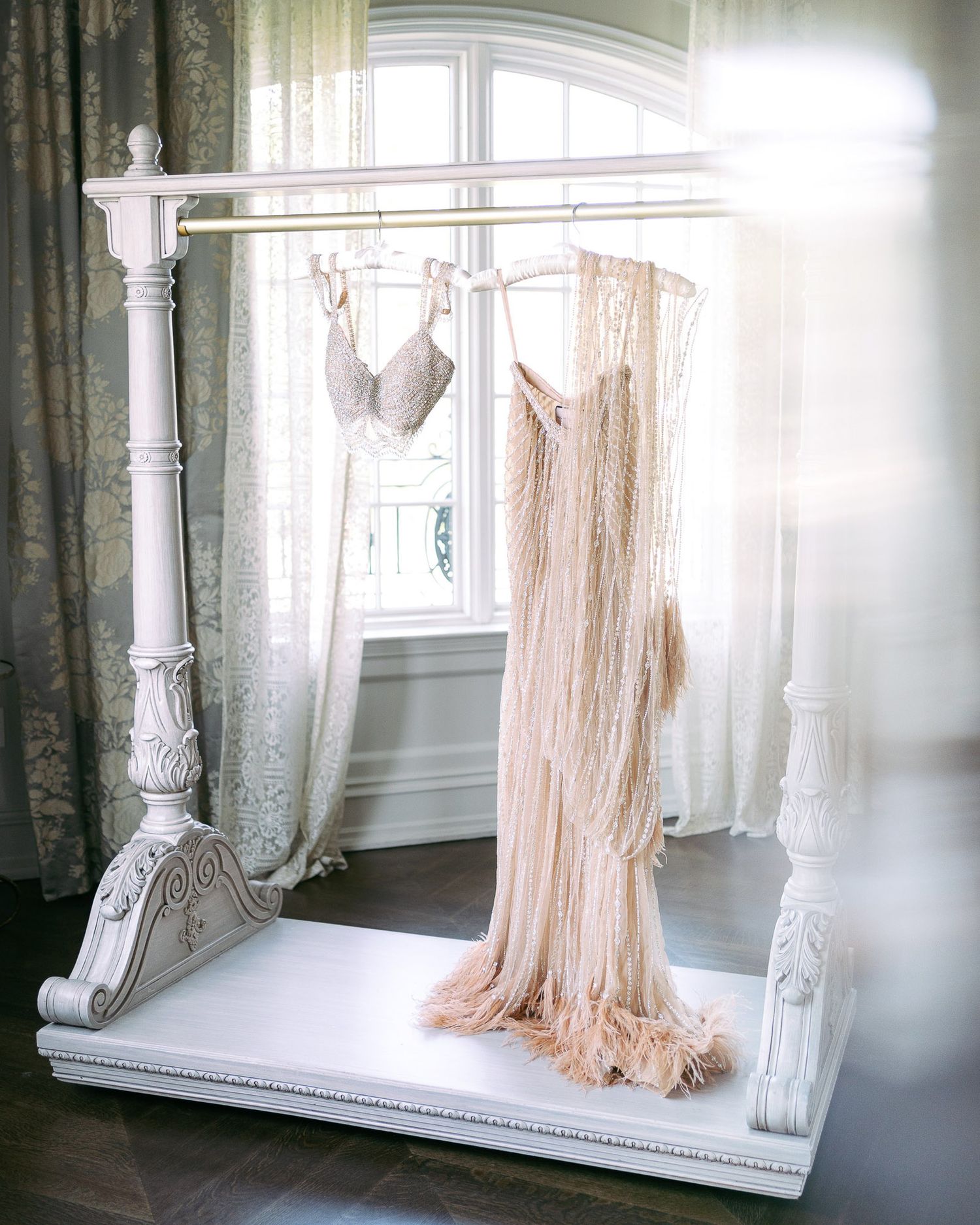A series of ethereal white curtains billowing by sunlit windows in a vintage interior space.