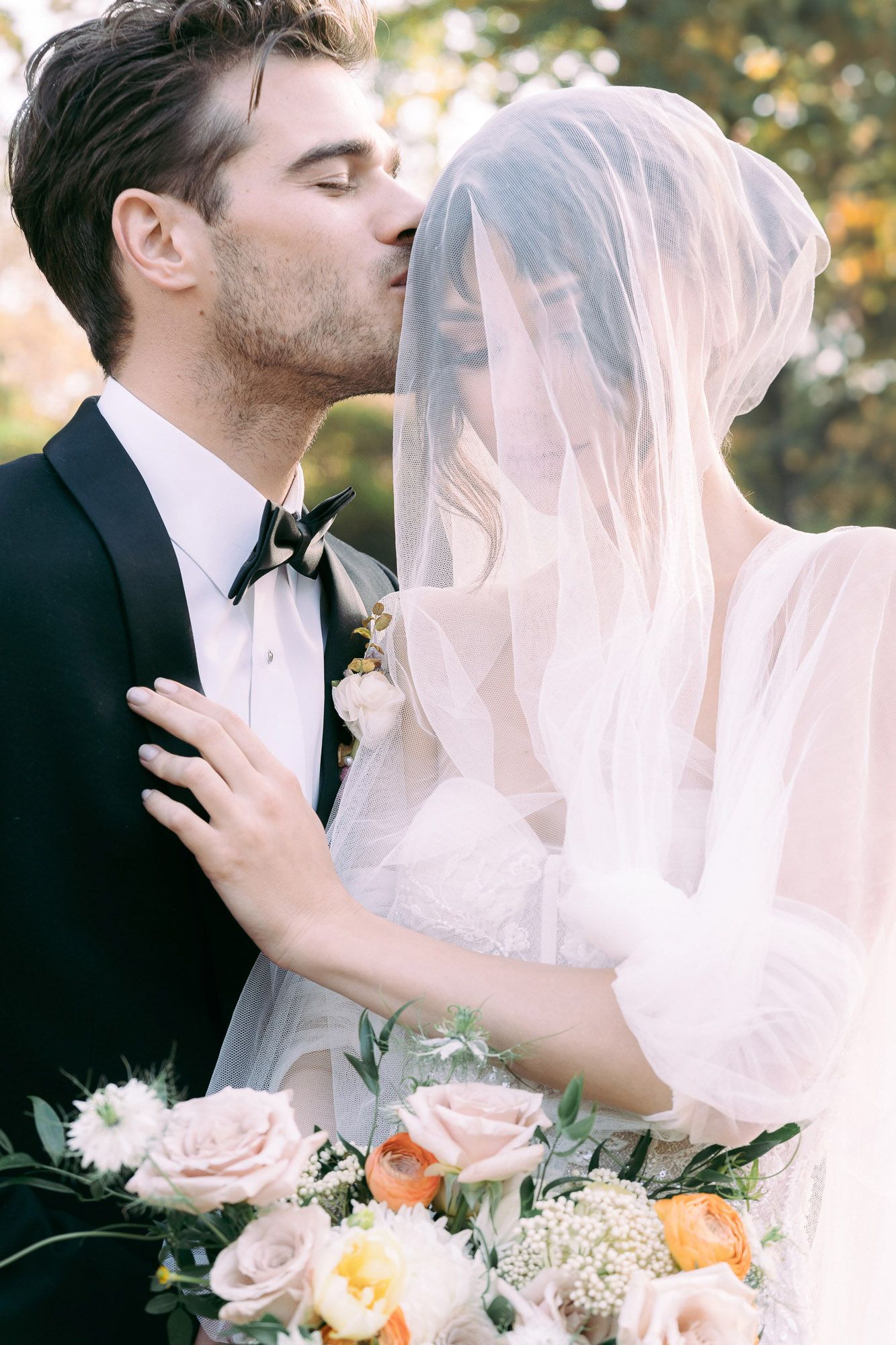 A romantic wedding photo series showing tender moments between newlyweds with a delicate veil and soft floral bouquet.
