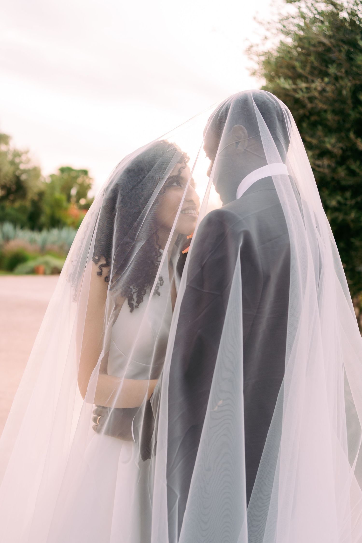 Artistic series showing ethereal white wedding veil details in natural light.