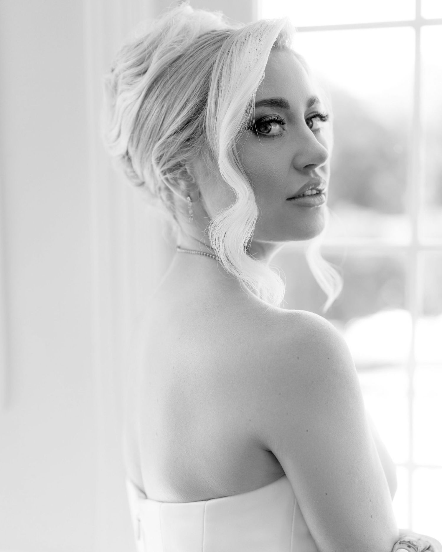 Artistic black and white bridal portraits showing elegant profile views in soft window light.