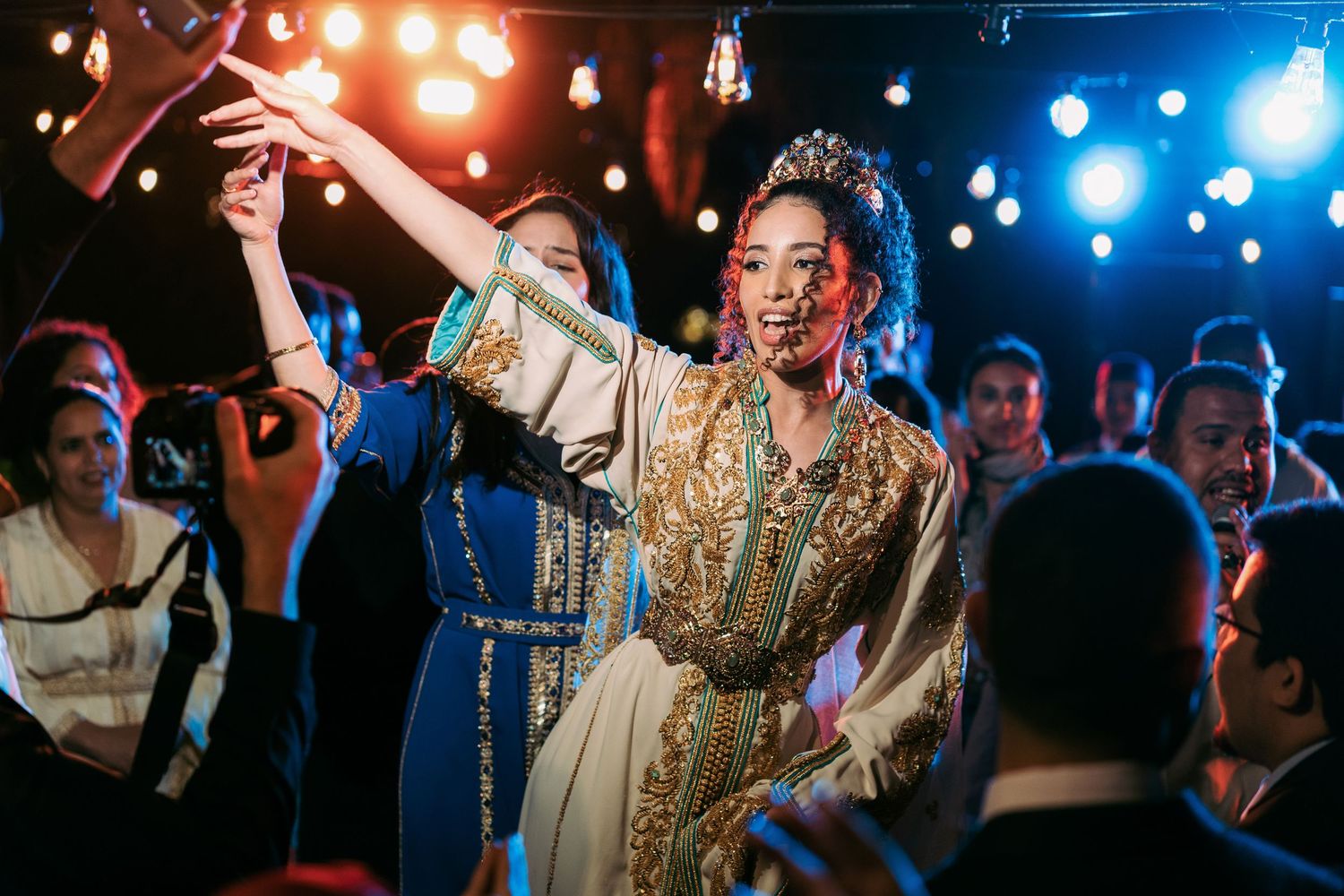 Wedding reception dance party with colorful stage lighting and celebration.