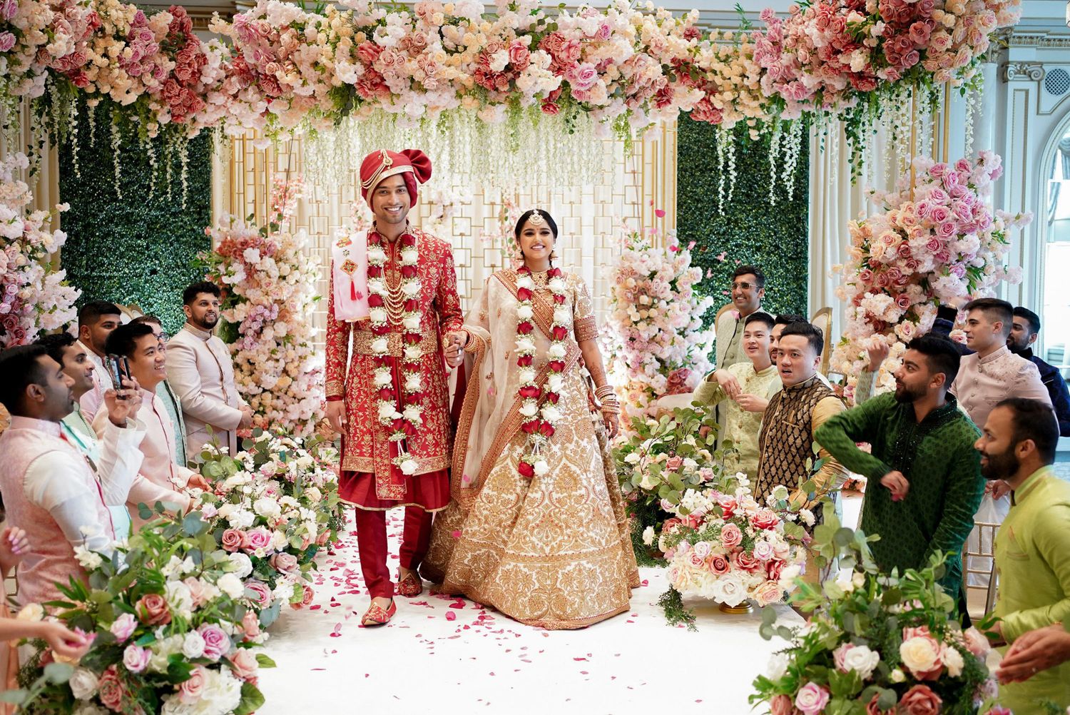 Traditional Indian wedding ceremony decorated with stunning pink and white floral arrangements and elegant decor.