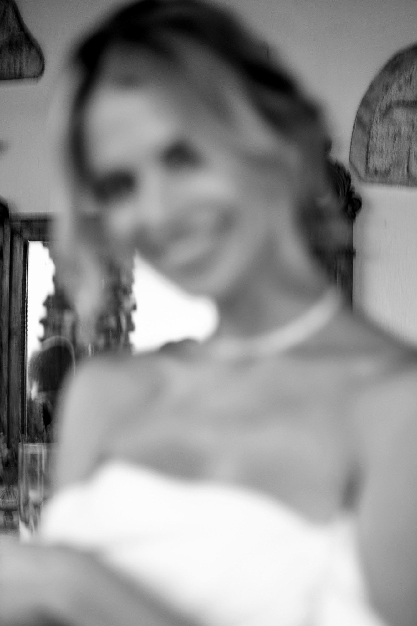 Artistic blurred black and white portrait of someone in a white dress creating a dreamy effect.