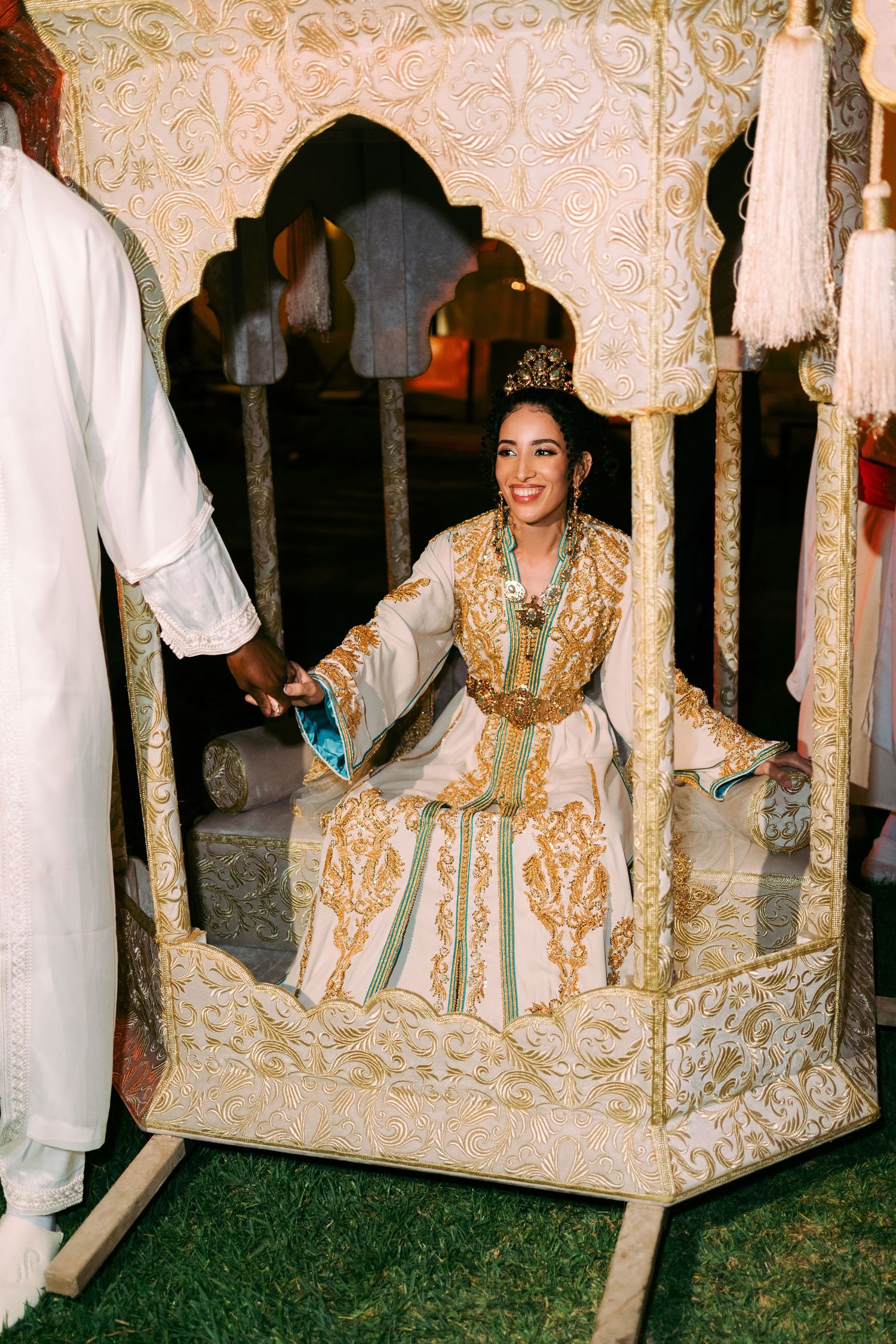 An ornate reception scene with traditional Moroccan style decor and seating arrangements.