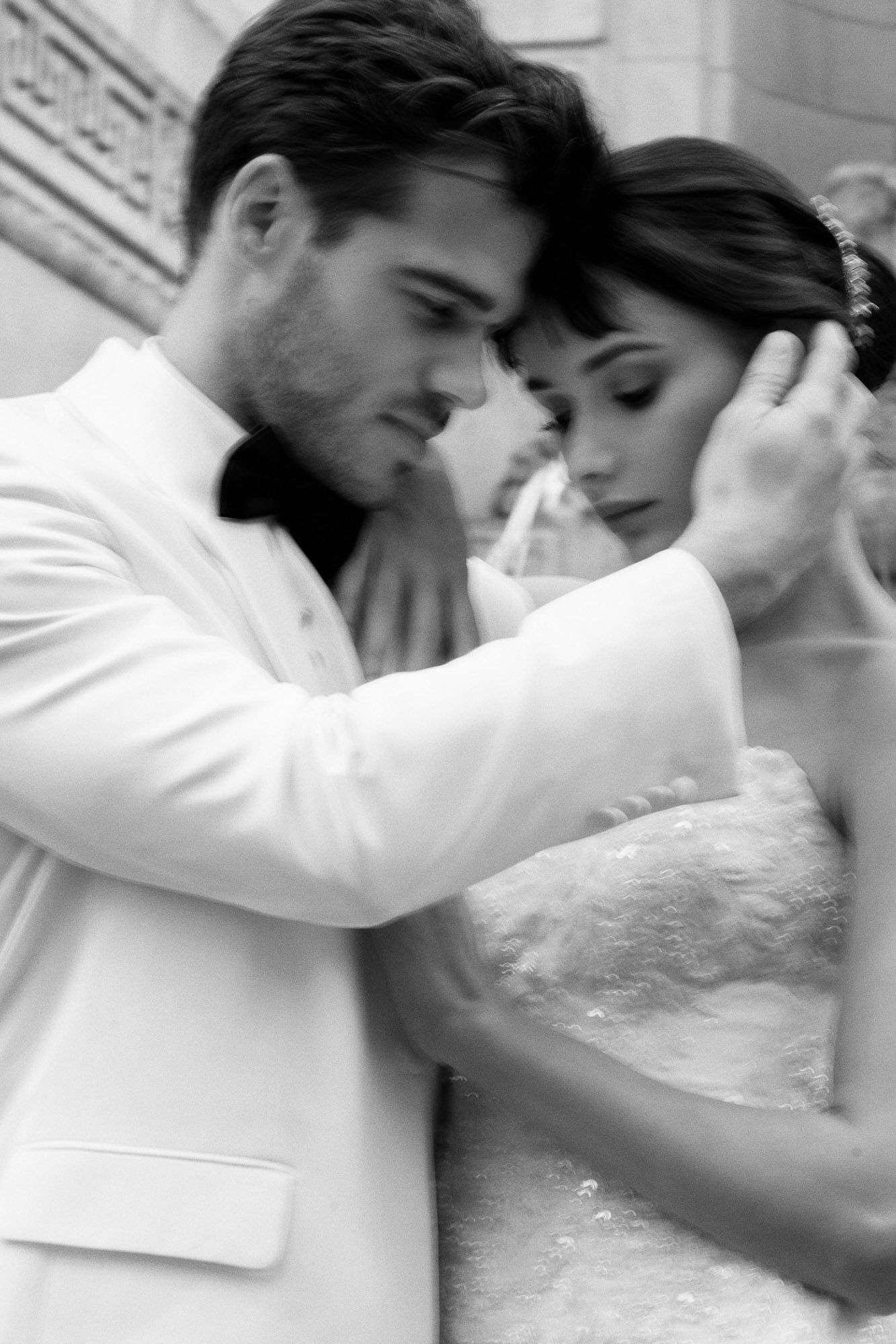 A romantic sequence showing tender moments between a couple in white attire.
