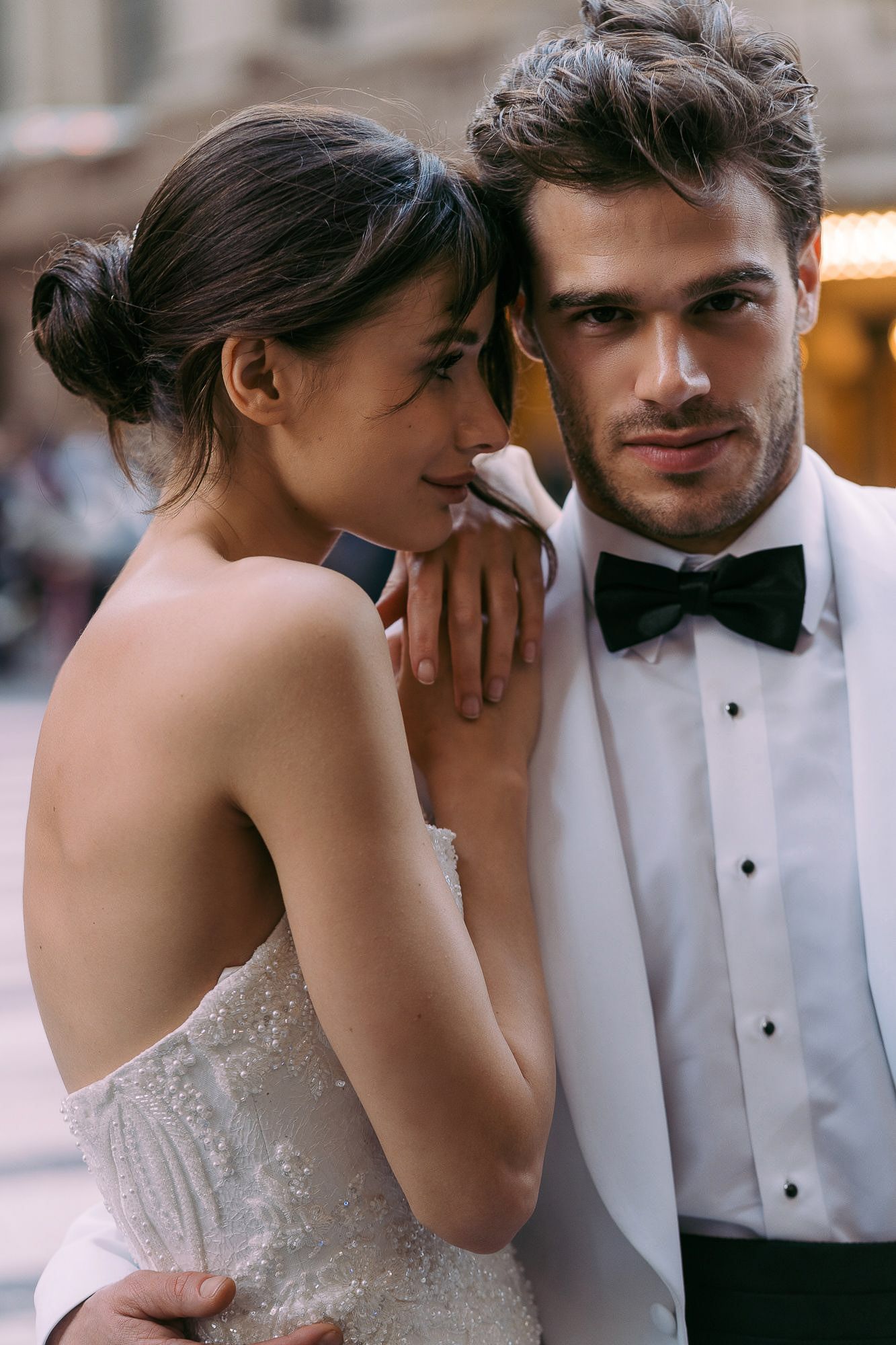 A romantic sequence of wedding photos showing tender moments between a bride in a strapless gown and groom in formal attire.