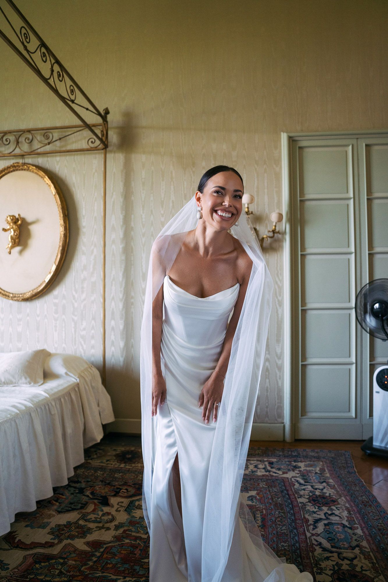 A sequence of artistic photos showing a figure draped in white fabric moving gracefully in an elegant room with ornate decor.