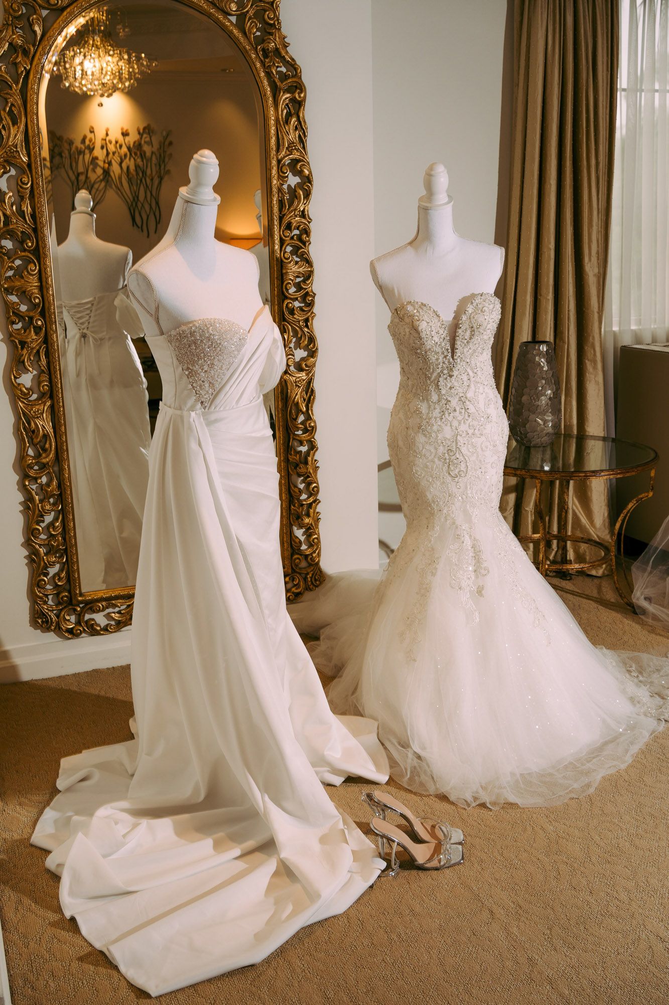 Multiple views of elegant white wedding dresses with intricate lace details displayed in a luxurious room with ornate mirrors.