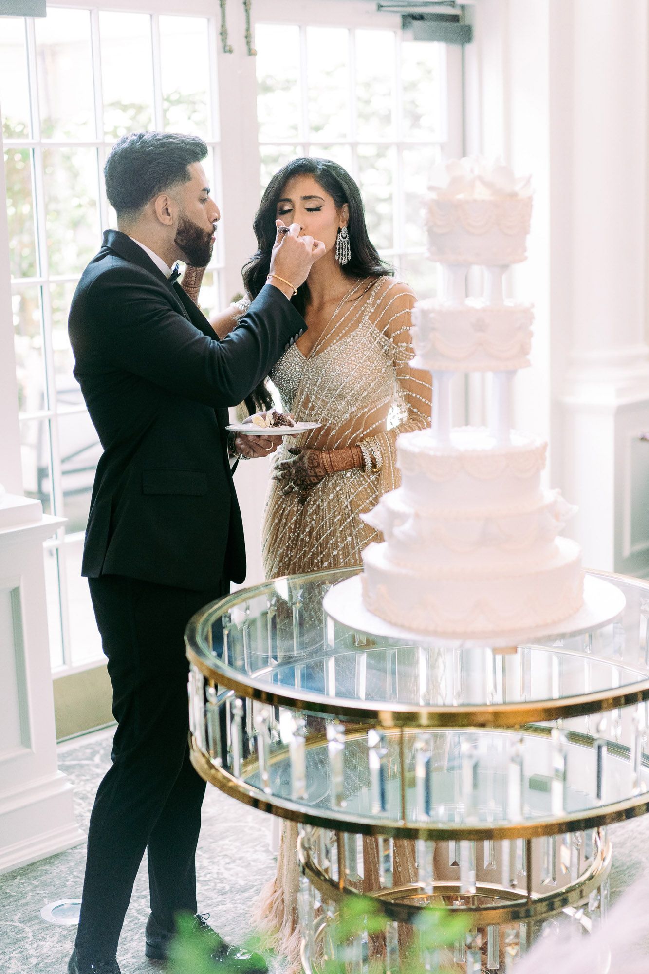 A romantic dance sequence captured in an elegant venue with glass windows and natural lighting.