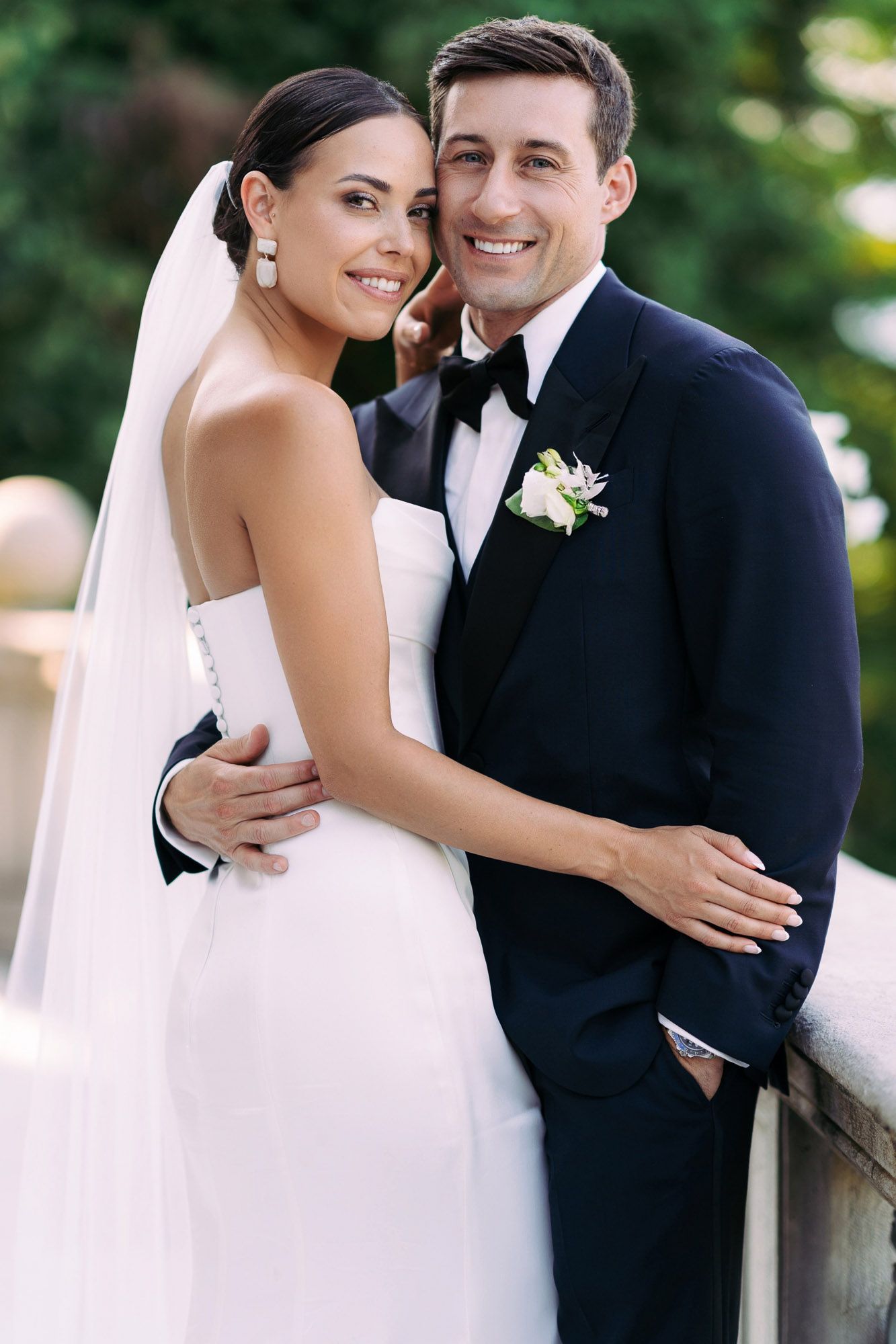 A bride and groom share intimate moments in a series of romantic wedding portraits outdoors.