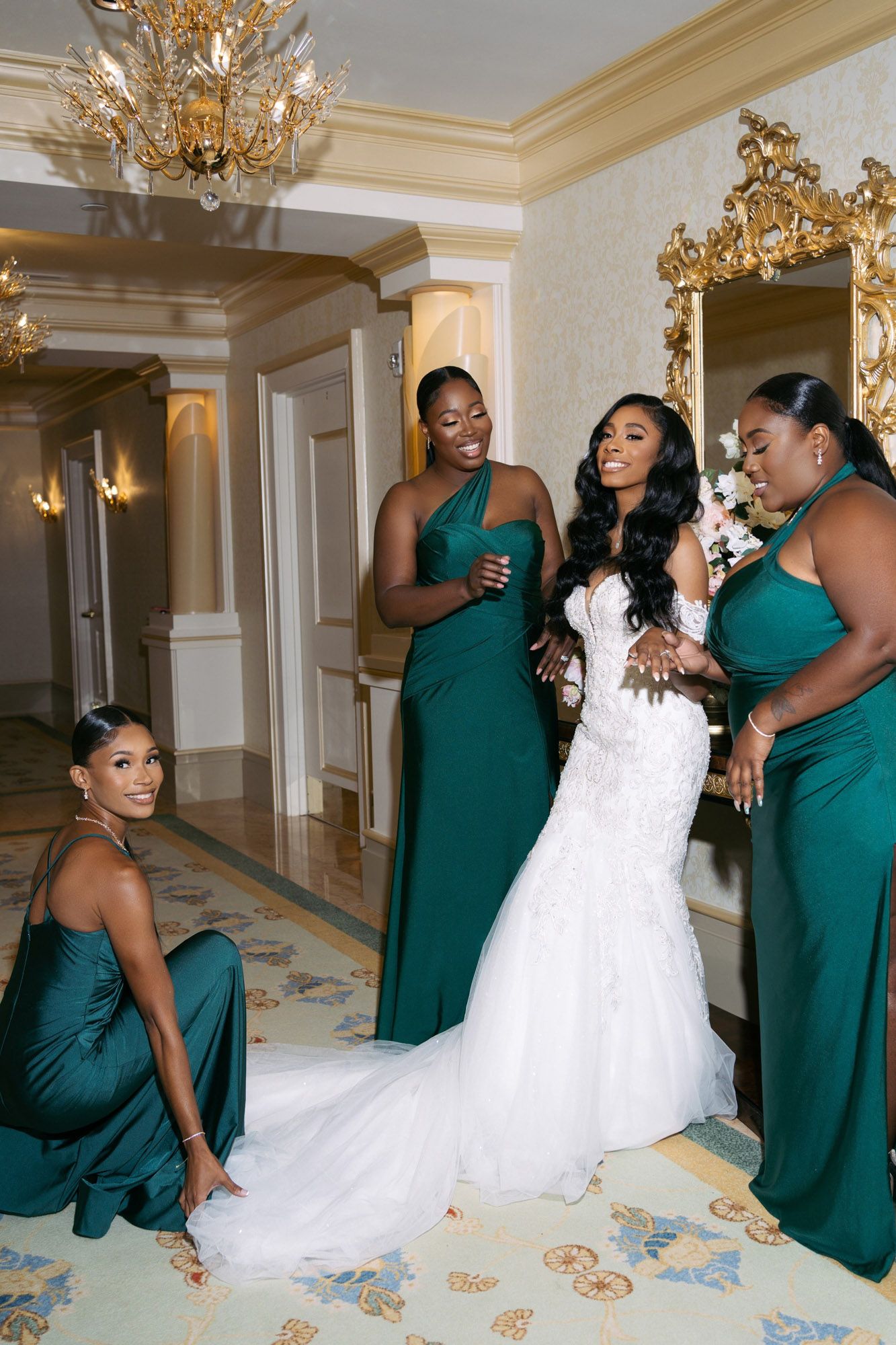 A sequence of playful dance moves between a bride in white and bridesmaids in emerald green dresses under crystal chandeliers.