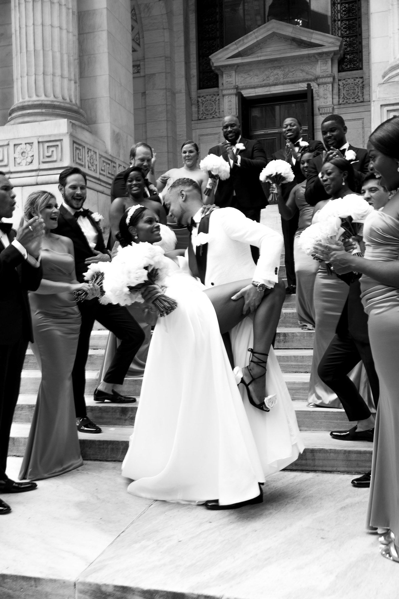 A black and white panoramic photo sequence showing a couple dancing together on steps outside a columned building.