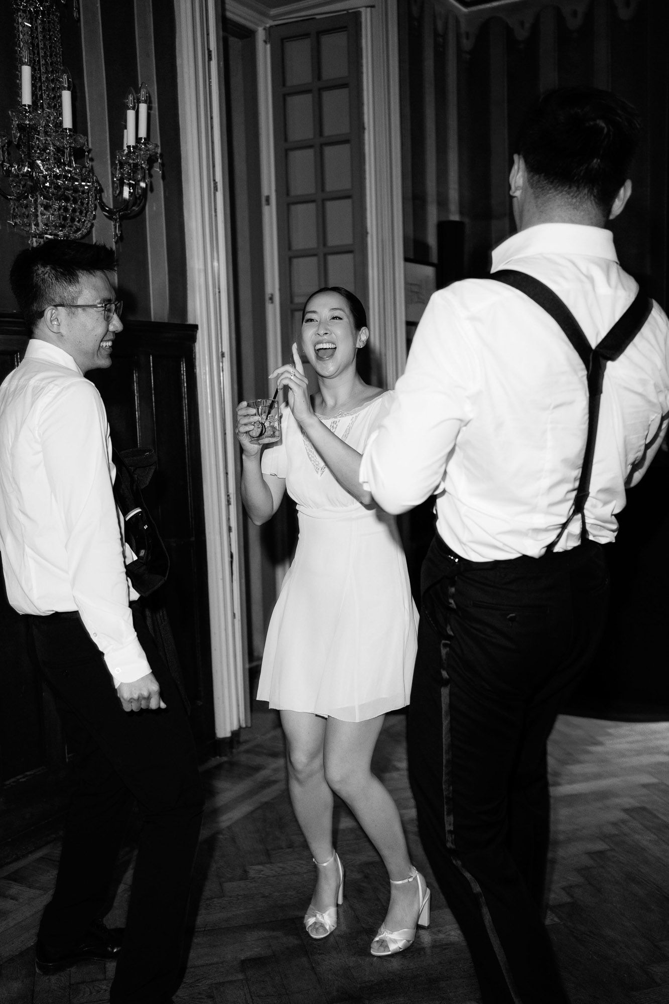 A sequence of black and white photos showing people dancing energetically at what appears to be a formal event.