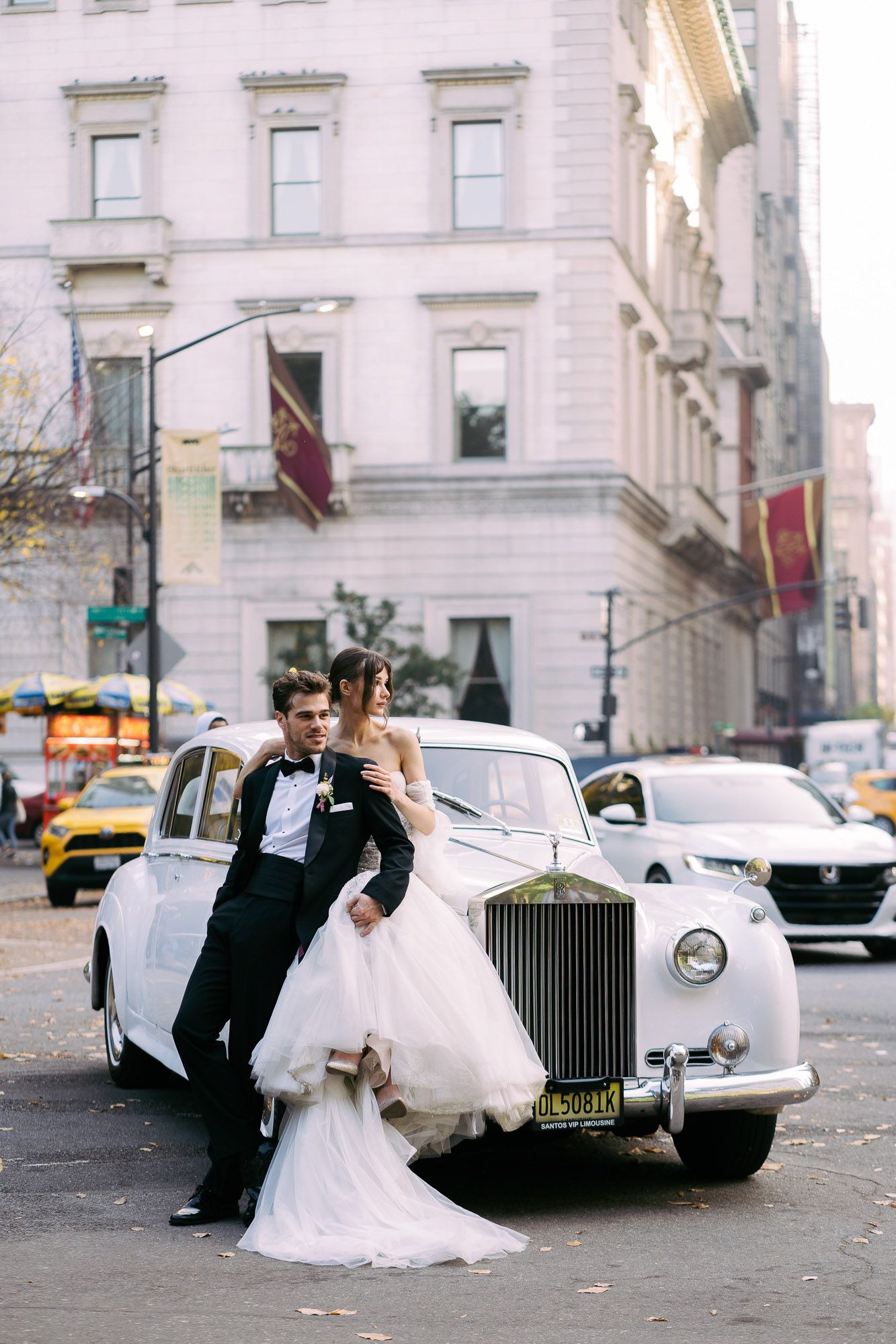 A series of wedding portraits with a couple posing beside a classic white Rolls Royce on a city street.