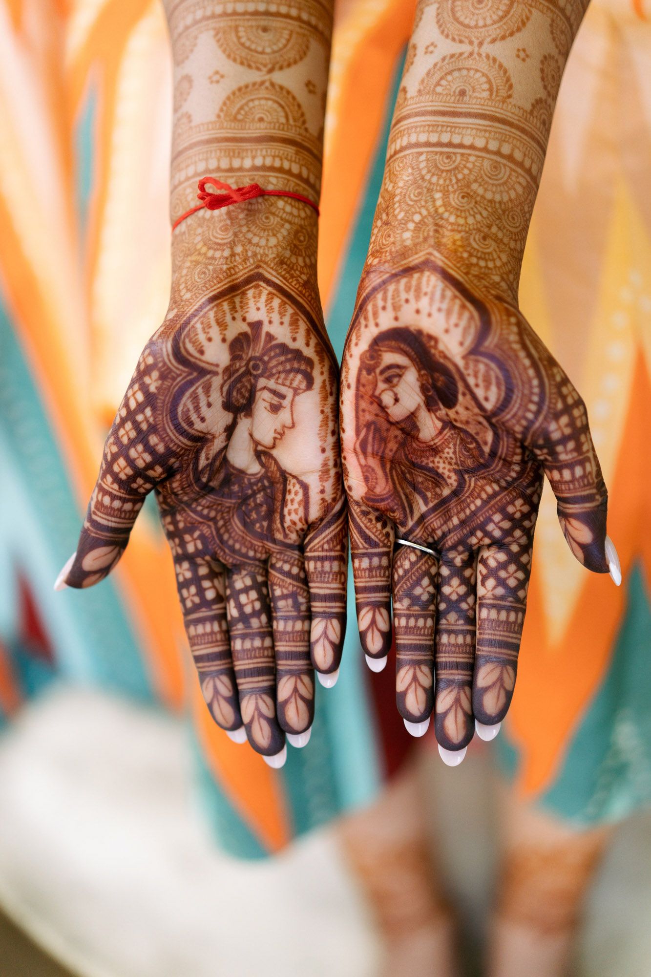 Detailed traditional Indian mehndi henna designs displayed on palms showing intricate patterns and motifs.