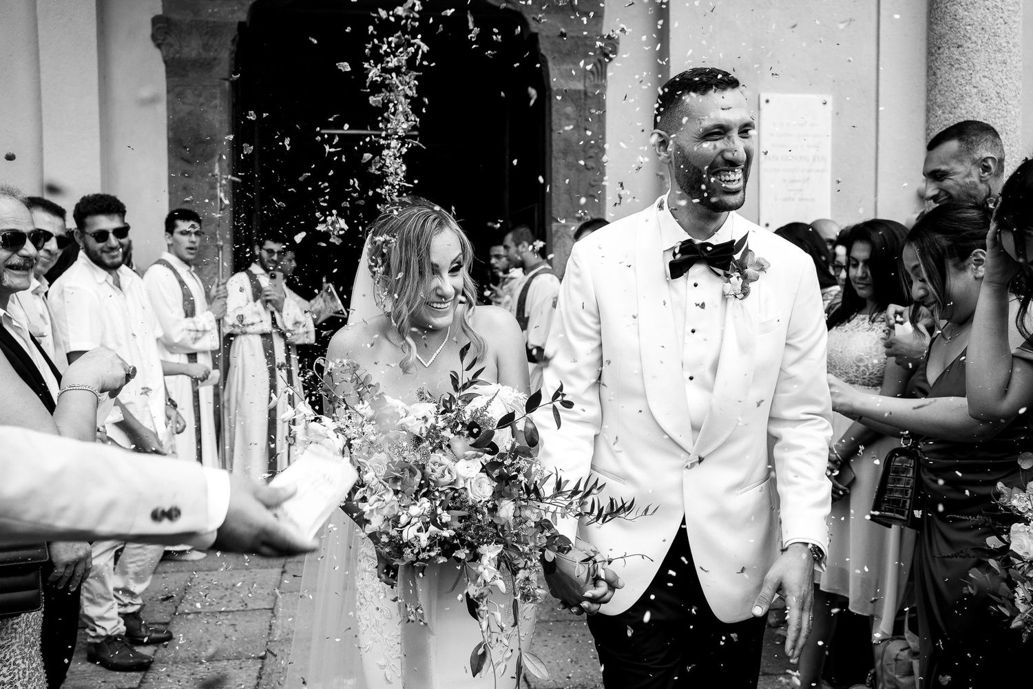 Wedding guests celebrate with confetti and joyful expressions during an outdoor celebration. wedding photographer Italy, Como, France