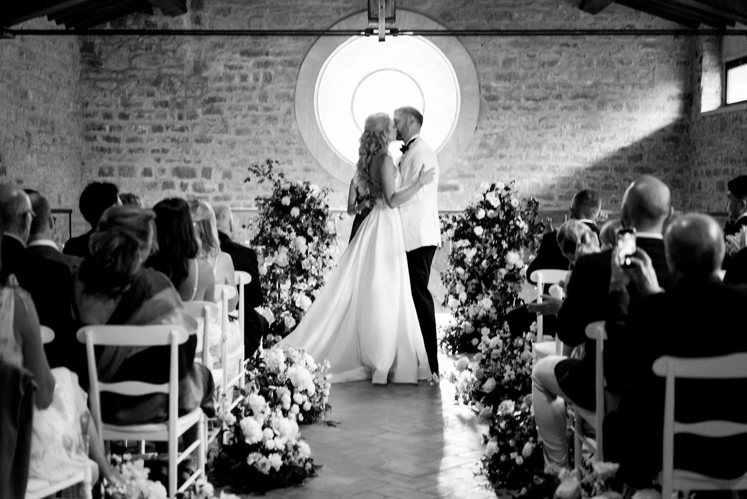 A romantic black and white photo sequence showing tender moments between a couple during their wedding ceremony.