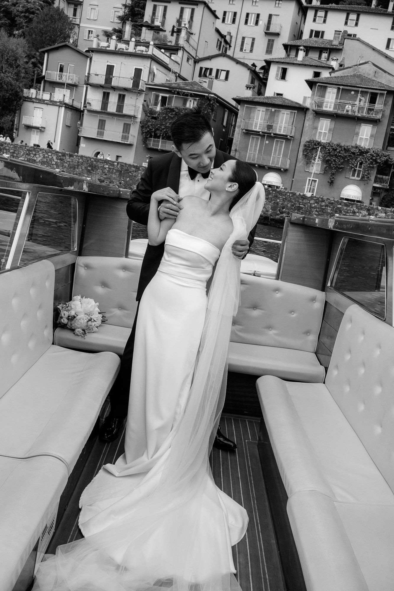 A sequence of black and white photos showing a bride in a strapless wedding gown twirling on a deck.
