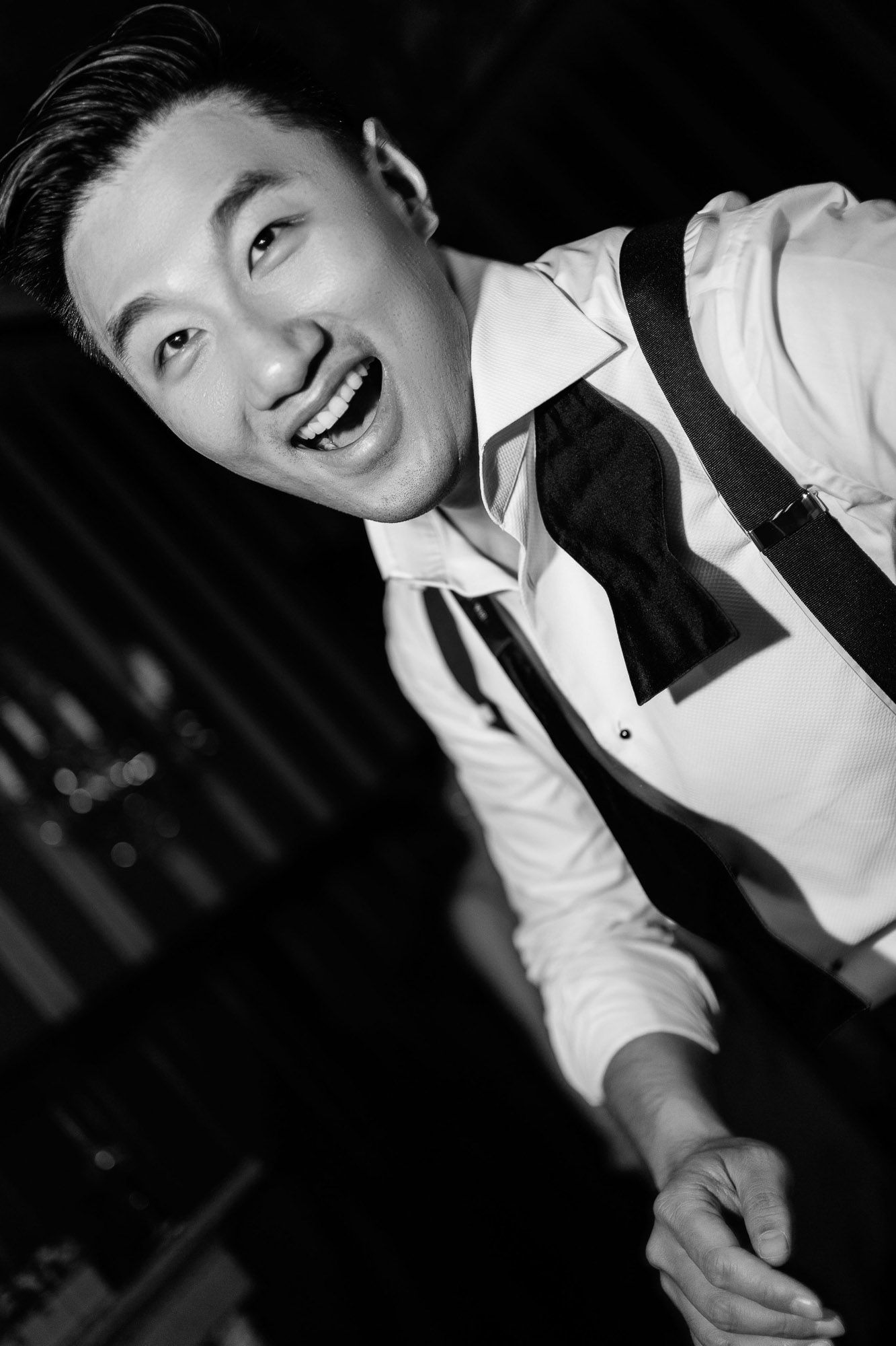 Black and white portrait series showing someone in white shirt smiling and gesturing with dynamic poses.