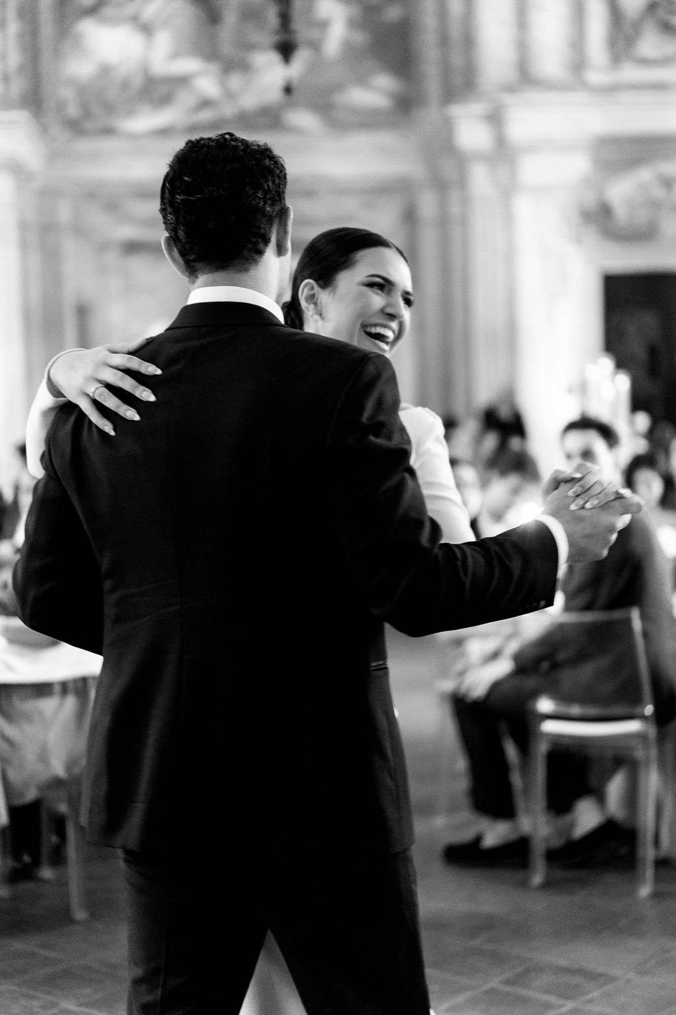 A black and white sequence of couples dancing at an elegant event, showing romantic movement and joy.