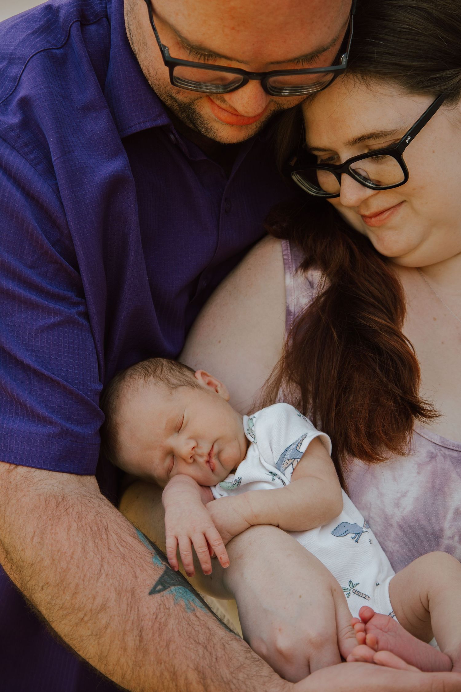 A couple cuddles their sleeping newborn baby in a sweet candid photo collage.