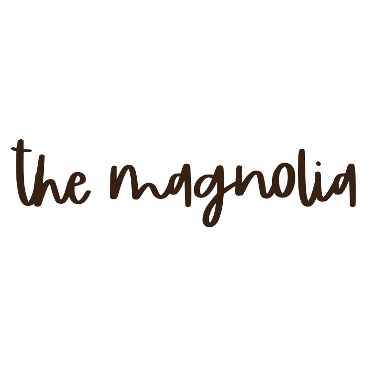 A handwritten text in brown ink reads 'the magnolia' with elegant cursive lettering on a white background.